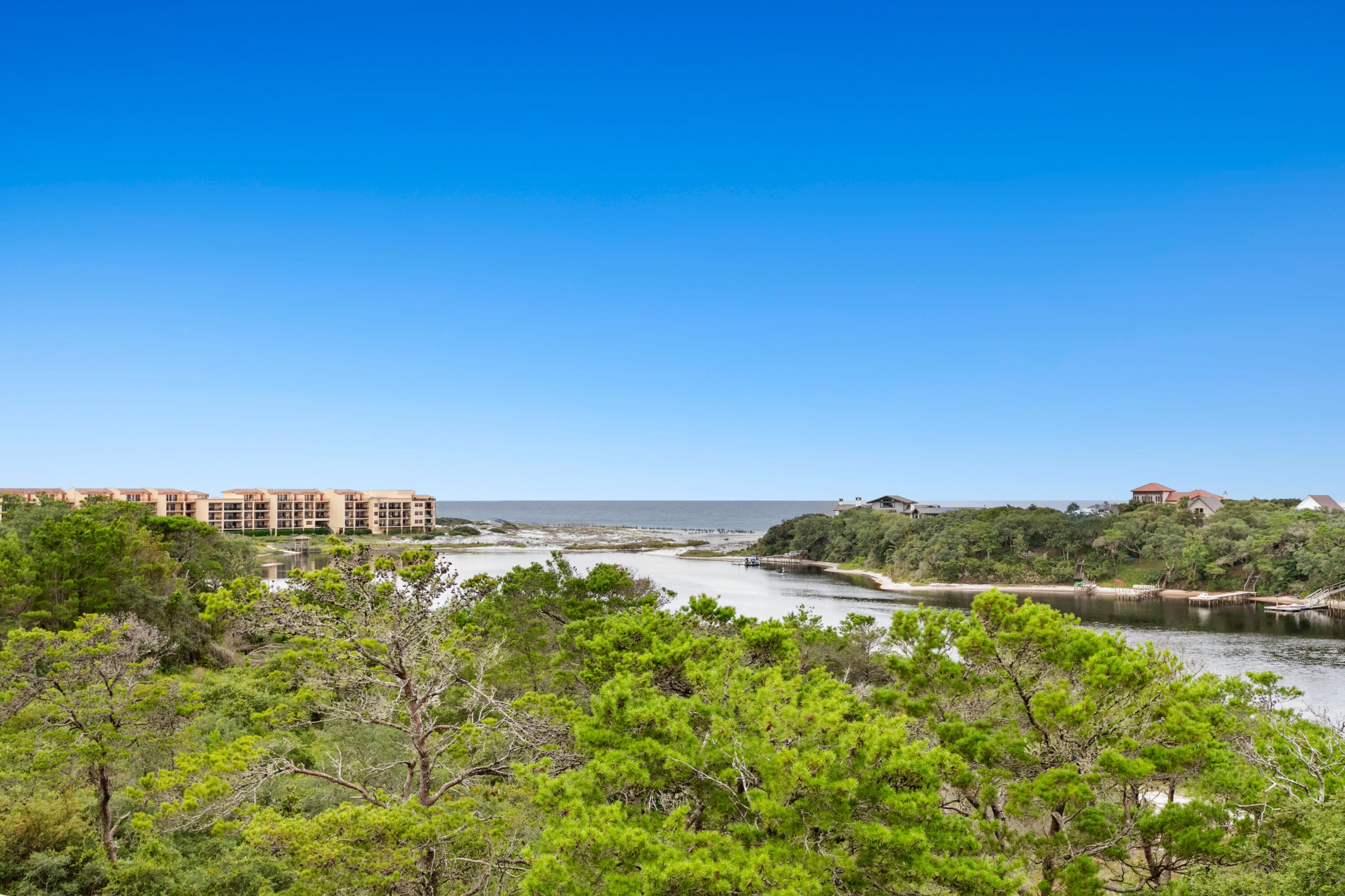 Enjoy the resort of Sanctuary at Redfish, south of 30A with a dock for fishing, kayaking and paddle boarding. Private water taxi is a quick ride to the beach or a short walk to the gated access across from the Preserve. Amenities include 4 pools, 2 hot tubs, fitness center, grilling deck and securely gated for the utmost in privacy. 2 car garage parking plus deeded storage cage.  This two story top floor unit features two master suites, 4 bedrooms and 4 1/2 baths. Nine foot ceilings, 2 spa master baths, and two living areas with views of the lake and gulf from the covered balconies. Coveted West 30A location. Used as second home and sold furnished and turn key with rental projections at $85,500.  Concrete and steel construction.