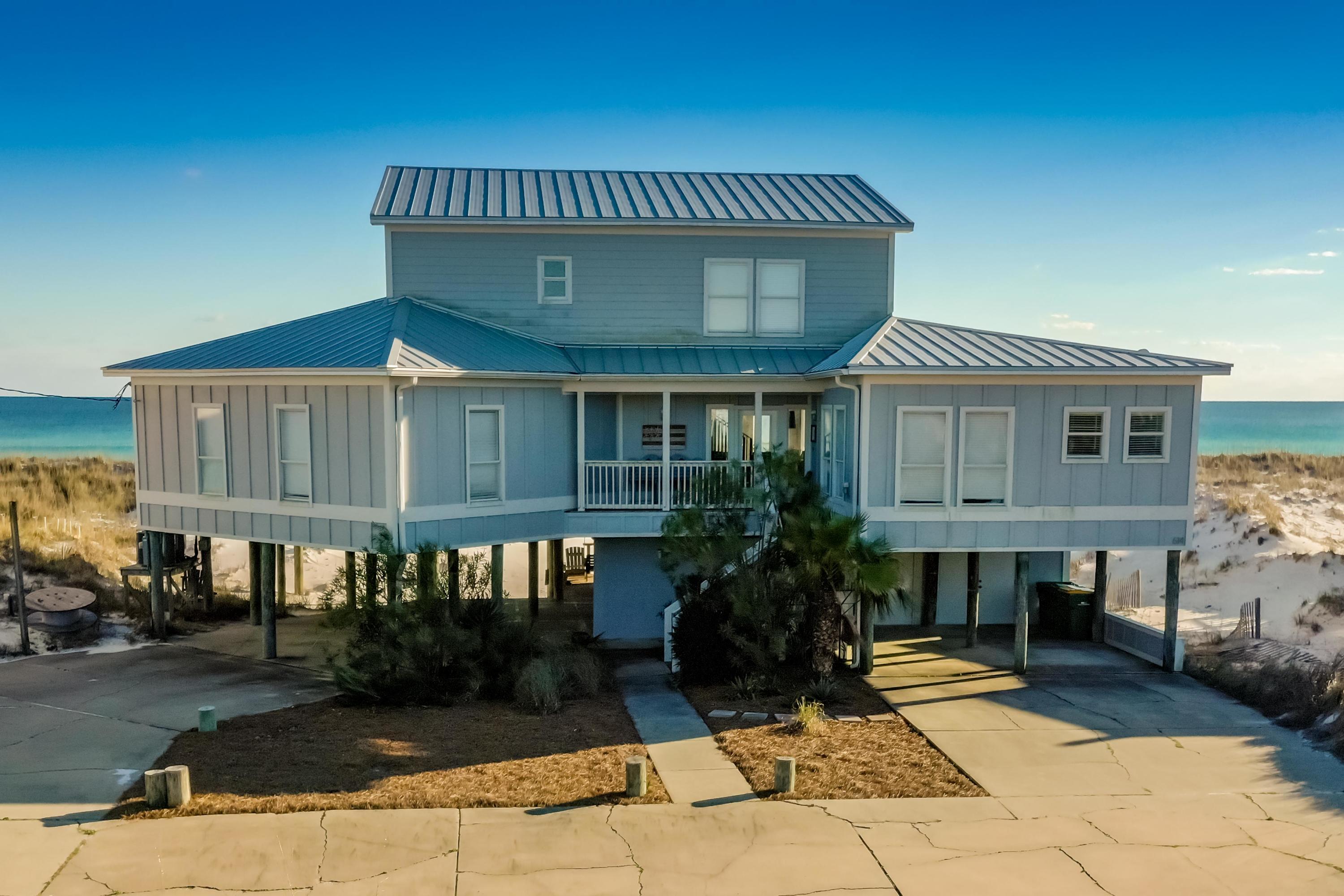 Property is under contract with a 72 hr kick-out clause. Enjoy breathtaking views from this Gulf Front beach house with an expansive deck on the back of the home. Situated on a HUGE lot on Holiday Isle, offering a 100 ft on the Gulf of Mexico and lot depth of approx. 400 feet. This home features four bedrooms on the second floor and 3 updated bathrooms, kitchen, dining room, living room and a flex room that is being used as a den currently. The entire upstairs is one huge entertainment room featuring a seating area, game room, extra sleeping space, another fully updated bathroom, deck and windows facing to the east, south and west offering more incredible gulf views. The ground level of this home features two storage areas, carport, entrance to the elevator, paved parking, outdoor shower, and a covered relaxation area. Elevator shaft in place from first to third floor and will convey in AS IS condition.