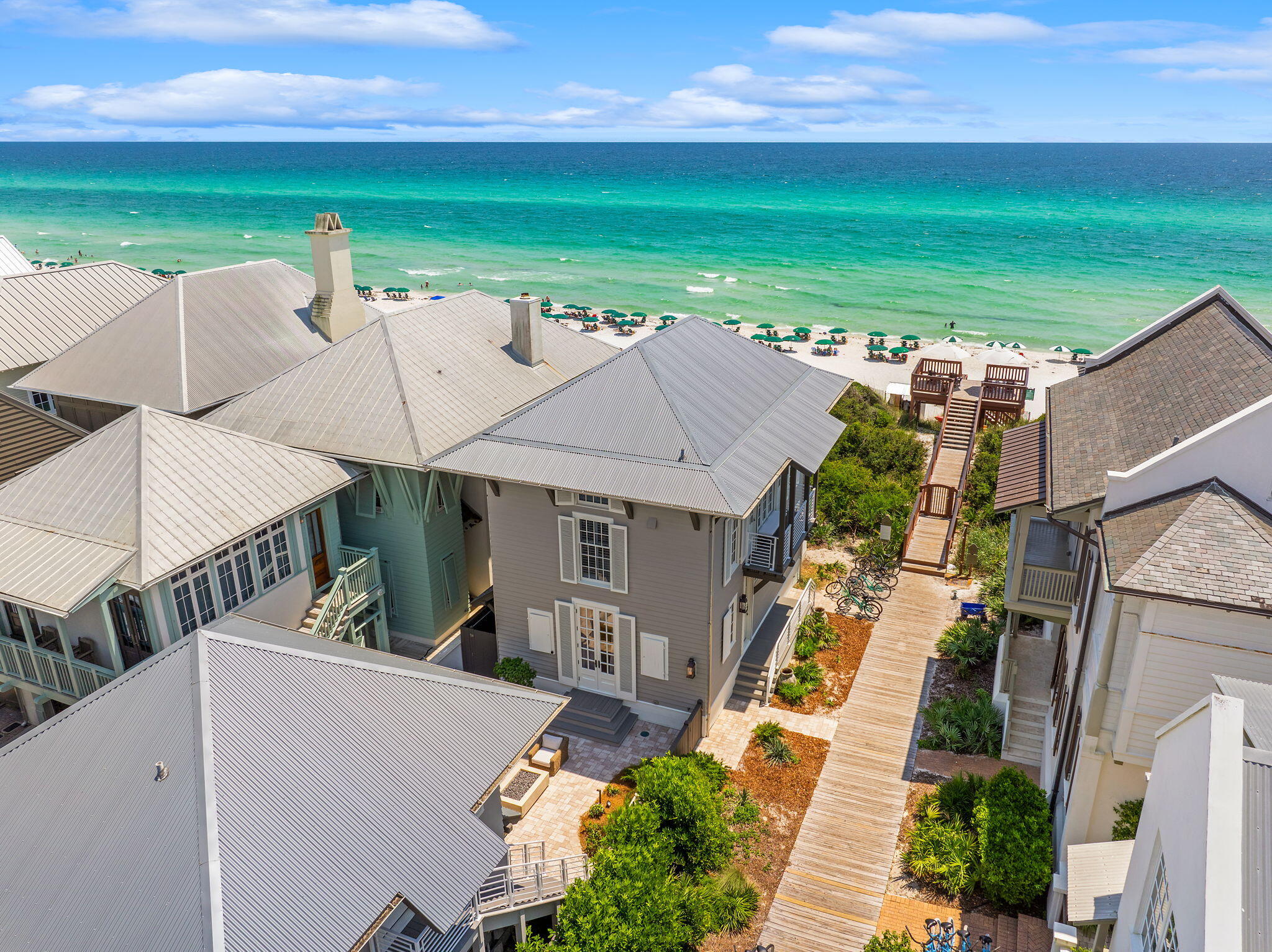 Immaculate coastal cottage has been completely renovated from top to bottom from inside to outside - no detail left unturned. Located in the most desirable neighborhood, Rosemary Beach, this rare oversized lot with front and side breathtaking ocean views is truly one of a kind. Situated next to boardwalk makes for an effortless and immediate walk to the beach.  The main house has 3 spacious bedrooms complete with en suite bathrooms providing a private sanctuary for all. The main level boasts magnificent panoramic views of the Gulf of Mexico.  A large living room/dining room/kitchen open floorplan makes it easy to entertain and relax after a day at the beach.  Additional guests can enjoy bedroom/bathroom upstairs or the carriage house across the courtyard that is complete with with kitchenette and private bathroom/living space. Courtyard situated in between main house and carriage house has a plethora of seating and is equipped with fireplace and outdoor kitchen making for a perfect afternoon BBQ or late night smore session. This house is sold completely furnished providing the new owner a seem-less transition into paradise.