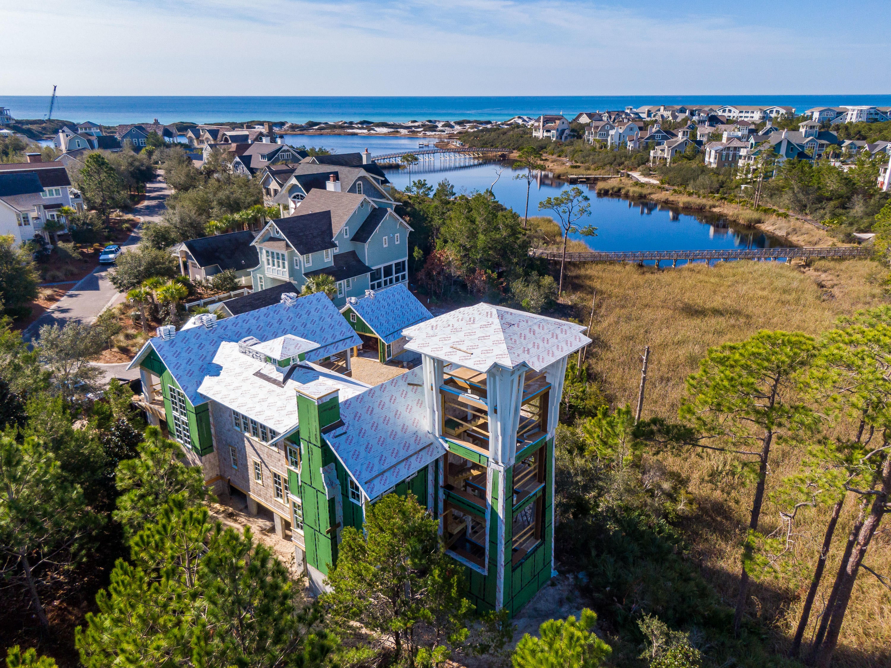 Discover a truly rare lakefront opportunity with this new construction 5BR/5.5BA WaterSound Beach estate nestled at the end of a quiet cul-de-sac in the Peninsula district to have an expansive outdoor retreat complete with an infinity edge swimming pool and spa, a private green, extended parking, and a two-car garage, all with spectacular lake and gulf views. Designed by Gregory D. Jazayeri Design and built by Dune Construction, find only the finest appointments throughout including a custom mahogany front door, wire brushed hardwood floors, solid wood cabinetry, Wolf and Sub-Zero appliances, frameless glass showers, designer lighting sourced from Bartlett Interiors, a Residential brand elevator, and IPE exterior decking. The first level offers the open-concept living and dining areas highlighted by a fireplace and bi-fold doors that connect to a spacious screened porch overlooking a golden marsh. The gourmet kitchen includes an oversized island, walk-in pantry, commercial grade appliances and doors that lead to the outdoor retreat. This level also includes a powder room, laundry room, and a guest room with ensuite bath and private porch. Upstairs, find two exquisite master suites each with private porches and two additional guest suites with direct access to a shared porch. A unique feature of this home is a five-level open air tower with views that become more stunning with each tier.

Both sophisticated and stylish, the gated WaterSound Beach community located south of Scenic Highway 30A offers homeowners a rare sense of seclusion with easy access to area activities. Amenities include swimming pools, a puttering park, community green spaces, a state-of-the-art fitness center and private boardwalks to one of the most beautiful mile stretches of coastline in the area.
