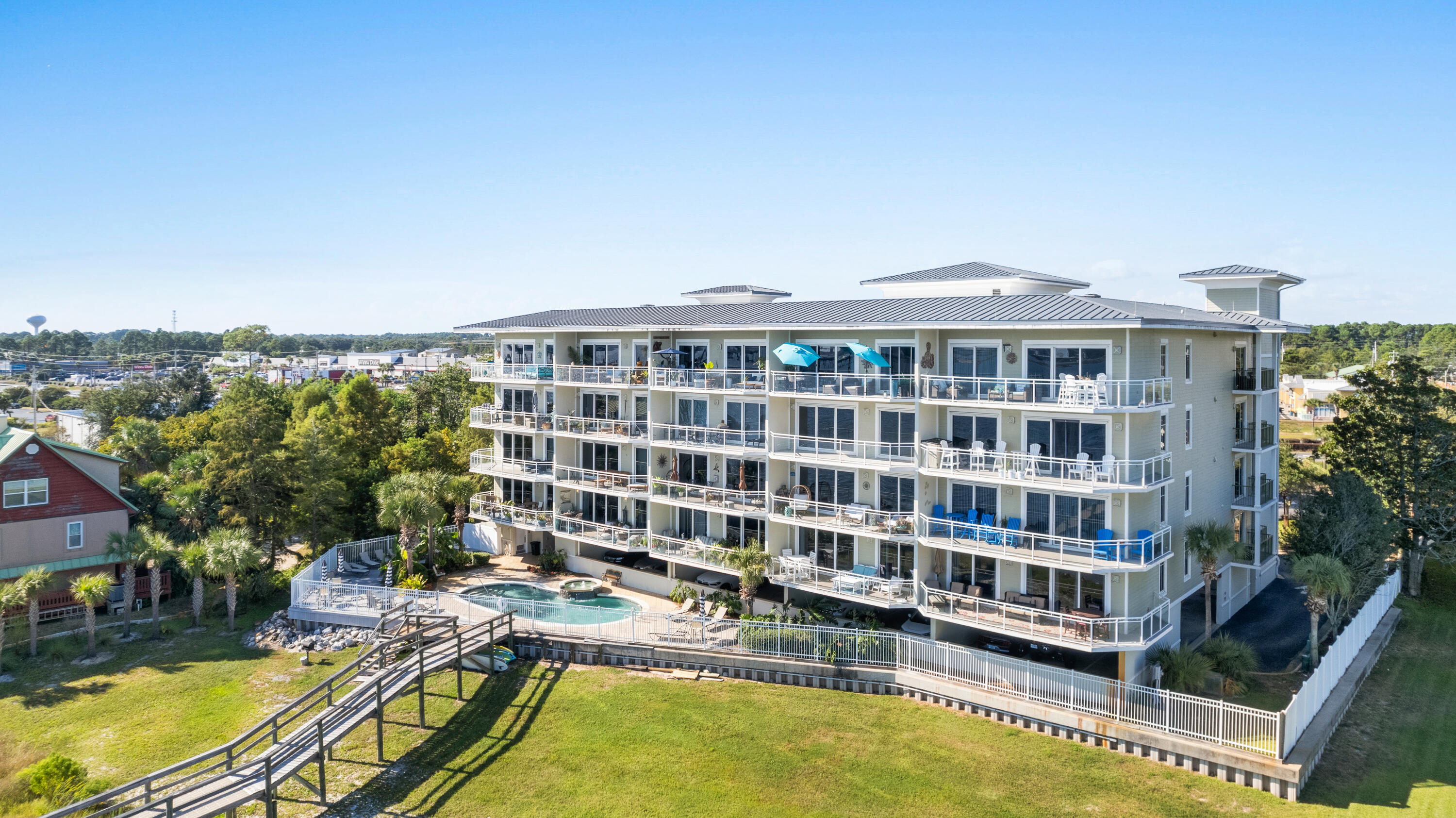 Come view the amazing sunsets at this three bedroom, three bathroom unit located on the inter-coastal waterway. This property is a gated 23 unit complex that each unit has a marked parking spot on the first floor parking garage.  A boat slip for a maximum 26 foot boat and a climate controlled storage unit are included are also included in this listing.  The HOA fees covers the water, sewer, high speed fiber internet, pool maintenance, all landscaping, building insurance and flood insurance.  The complex is an easy walk or kayak trip across the inter-coastal waterway to Navarre Beach.  Short term rentals are allowed and the location is in the Heart of Navarre and there are many local restaurants, retailers, grocery stores and coffee shops in the vicinity.
