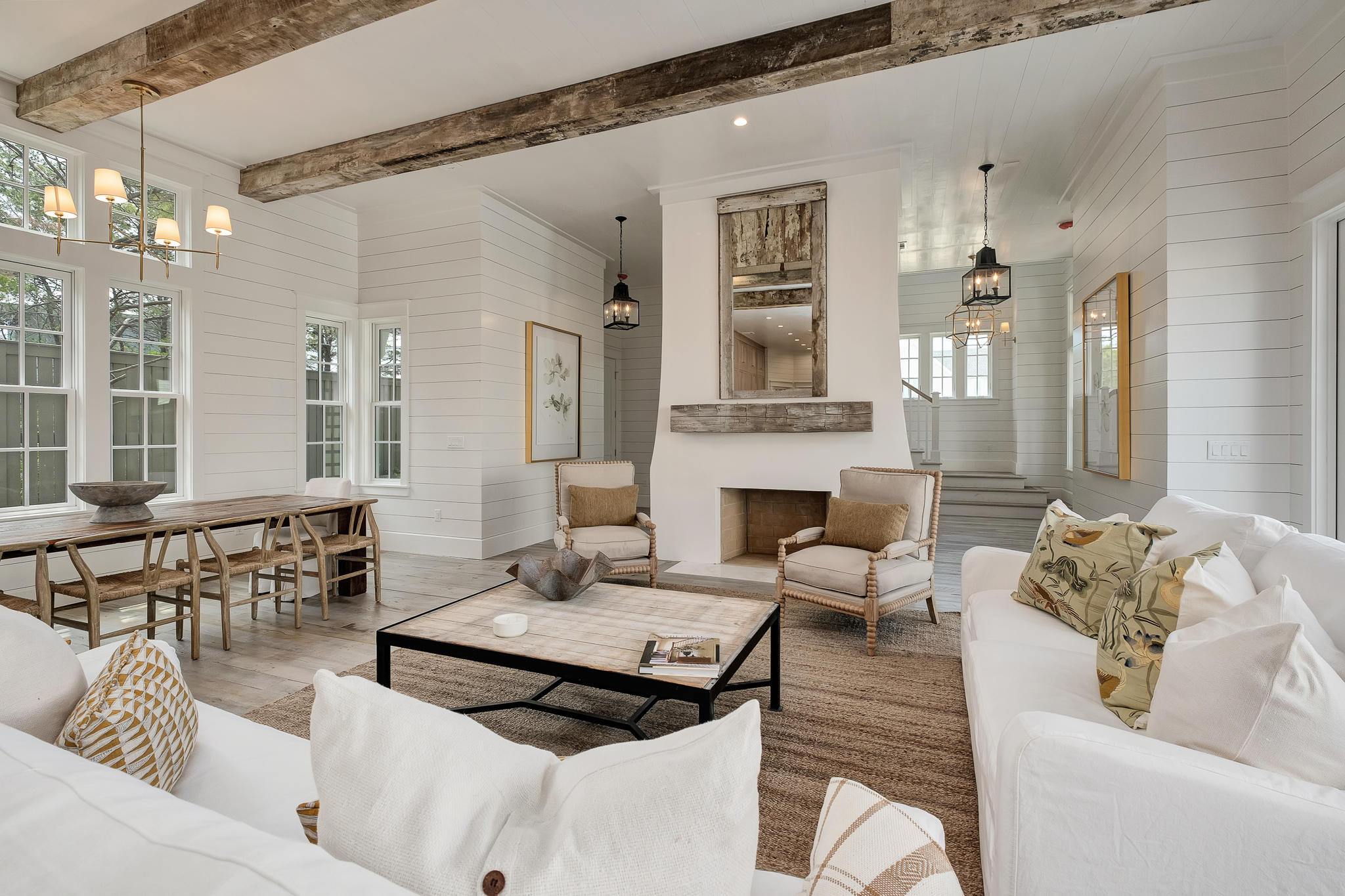 Enjoy the breathtaking views from the Hamilton at Grace Point, ready to begin a new chapter of 30A living at its very best under new ownership.This exemplary property is being offered with a custom designer furnishings package boasting a balanced blend of coastal chic, wood tones, and select fabrics and textures.
With a layout well suited for a multi-generational family, the residence offers over 4700 square feet of living space with a flowing floor plan, large two-car garage, elevator, private pool with large patio surround and custom touches throughout the home. The overhead rustic beams will captivate you the moment you step into this very special home. Hardwood floors throughout the home are of salvaged wood for a distinctive elegance on every level.
Centered with a gas fireplace with Venetian plaster surround and rustic beam mantel, the gracious family room is filled with natural light through a wall of accordion doors, which creates a fusion of indoor and outdoor living. The great room flows seamlessly from dining into the kitchen, perfect for entertaining or family gathers. Offering custom floor to ceiling built-ins, and anchored with an oversized island, a professional suite of Subzero and Wolf appliances and quartz countertops. The first- floor master suite with private courtyard access and ensuite offers Carrera marble, custom cabinets, and large walk-in glass shower. An oversized 1st-floor laundry room, office nook, and powder room complete the first floor.
Each floor of the residences provides a retreat after your day at the WaterSound Beach Club, or on the links at Camp Creek.  The multiple family areas for reading, games or movie nights, balconies, and large light-filled rooms. The junior suites throughout the home are complete with private bath, outfitted in Carrera marble, providing a lavish comfort to guests.  Take the stairs to the 4th-floor tower for stunning views of the Gulf and enjoy a nightcap at sunset or stargaze on your endless summer nights.
One can simply step off their front porch and walk thru the manicured park to the WaterSound Beach Club and easily access the beach through the private gate. Grace Point offers easy access to the HUB on 30A, Seaside, and Rosemary Beach, allowing easy access to all of the activities and events along 30A. Owners at Grace Point can enjoy a lifestyle membership to the WaterSound Beach Club, including Camp Creek, Sharks Tooth, and the private dune walkovers to the pristine private beaches.