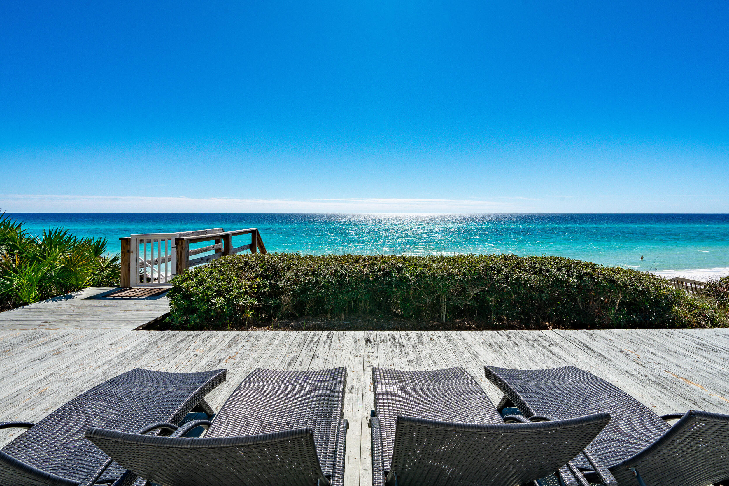 60 FEET OF GULF-FRONT PROPERTY rarely available in Seagrove Beach!   This rare one-level Gulf-front home in Seagrove Beach offers a coastal living experience like no other. Located along the stunning white sandy beaches of 30A, the home is ideally positioned just adjacent to Seaside, placing it in one of the most sought-after areas in the region. The interior features a bright and airy coastal design, with an open-concept living, dining, and kitchen area that seamlessly flows to create a welcoming space for family and friends.
The residence offers both privacy and convenience, with the added benefit of being just across the street from a fine dining restaurant and the family-friendly Seagrove Village Market. Easy access to Seaside is also available via the scenic 30A bike trails, making this home the perfect retreat for those who enjoy a blend of relaxation and adventure.
The Gulf-front master bedroom offers breathtaking views, while two additional bedrooms provide ample space for guests. A bonus room off the garage offers versatile options, whether it's used as an office, media room, or bunk room. Perched on one of the highest points in the area, the home boasts a private deck area that overlooks the Gulf, offering stunning views of the water.
The property is beautifully appointed with granite countertops, stainless steel appliances, tile flooring, cement fiber siding, and a standing seam metal roof. It is being sold fully furnished, with a list of exceptions provided by the seller. The home's prime location means you'll have easy access to all the shopping, dining, and attractions that Seaside and Seagrove have to offerall without the burden of HOA fees.