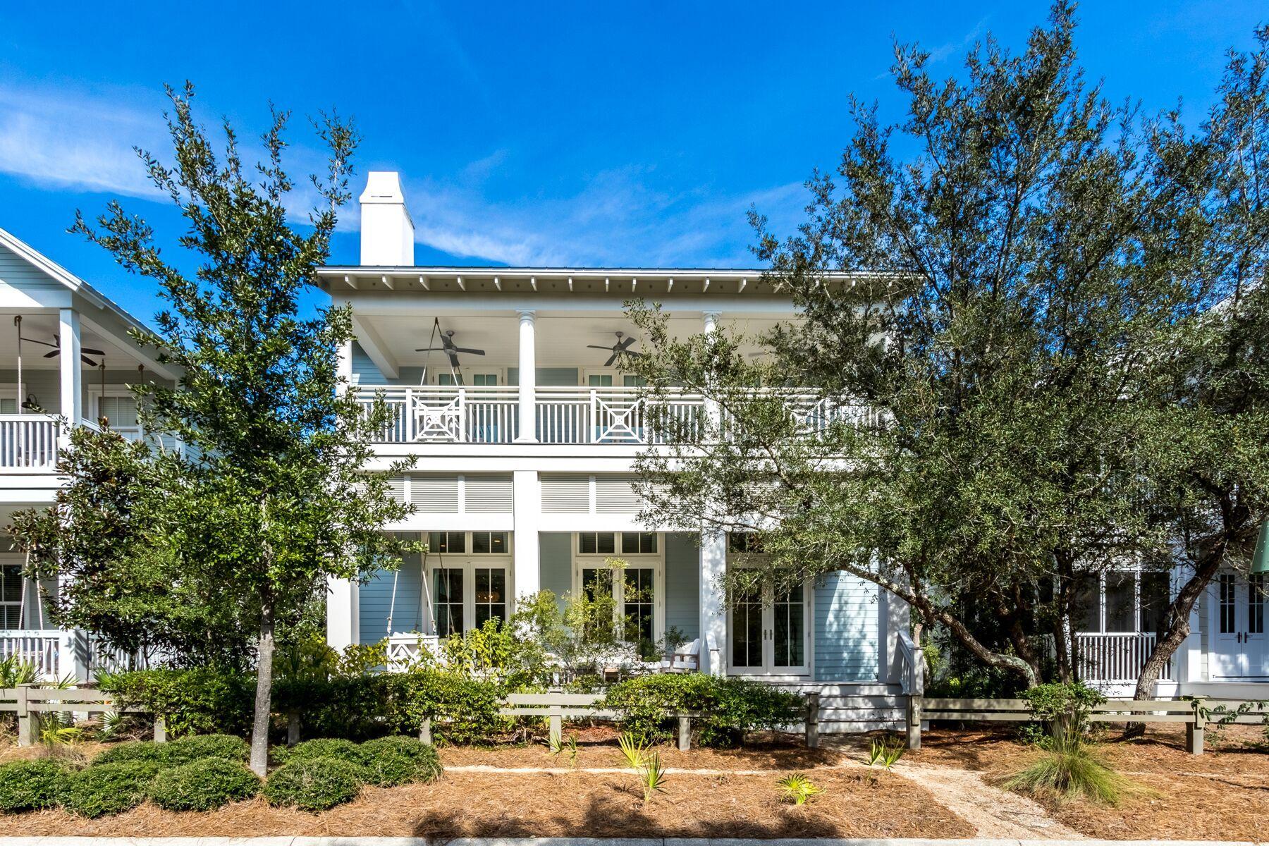 Tucked away along a remote stretch of Bluejack Street, this six-bedroom beach house overlooks pristine nature preserve and wooded walking trails offering added privacy in Phase 3 of WaterColor. This two-story beach cottage welcomes guests with an expansive covered front porch that boasts a swing bed and comfy outdoor living space made for enjoying life in WaterColor. A wall of double doors with transoms greets you as you enter the light and bright, open concept great room wrapped in shiplap and featuring beachy whitewashed wood floors. Offering a spacious seating area made for conversations, and a large living room space finished in coastal charm with a floor-to-ceiling seashell tabby gas fireplace; this space flooded with natural light was made for gathering and features soaring 12-foot ceilings. The dining room presents a modern farmhouse dining table with custom benches and seating for eight topped by a beautiful glass chandelier. The large coastal kitchen offers custom ceiling height cabinetry and a huge kitchen island with breakfast bar seating for five and tons of storage options, crowned by two glass chandeliers. Boasting a double window over a tub sink, this kitchen is finished with a Wolf gas range, dishwasher and Subzero fridge. Made to entertain, the wet bar area is ready to party boasting a wine fridge, ice maker, and mini fridge. Off of the kitchen you can find a spacious laundry room and a hallway to a half bath that leads to the main floor master suite. Featuring a walk-in closet and large windows with transom lights, the main floor master suite offers an ensuite bath wrapped in shiplap with a double vanity, soaking tub, glass shower and water closet. The back foyer is a great drop zone to kick off your shoes and hang your coats with easy access to the paver driveway and covered carport located at the back of the home. Featuring an outdoor shower, grilling area and lots of bike parking, this dual-purpose backyard space is great for hosting family and guests.  Off of the front door, shiplap walls carry you up to the second level, where you will find a second laundry and large linen closet just across from a full bath that services a huge bunk room. Featuring four built-in bunks and a bonus living room area, this retreat is fit for the kids and even the kids at heart. The spacious primary master suite is located at the front of the home with his and hers closets, a luxurious ensuite bath offering dual vanities, a soaking tub, glass shower and watercloset, as well as, as large private porch. Boasting a swing bed and the perfect place to enjoy a cup of coffee while overlooking the solitude of this serene stretch of Bluejack Street, the master suite's covered porch is a great place to unwind. Down the hallway wrapped in shiplap wainscoting, you can find two large guest ensuites and a well-lit reading nook with window bench seating and added storage. At the back of the home you will find an expansive guest ensuite with a spacious living room area and lofty vaulted ceilings. This custom 4,198 square foot WaterColor home is one of a kind and must see on Bluejack Street.