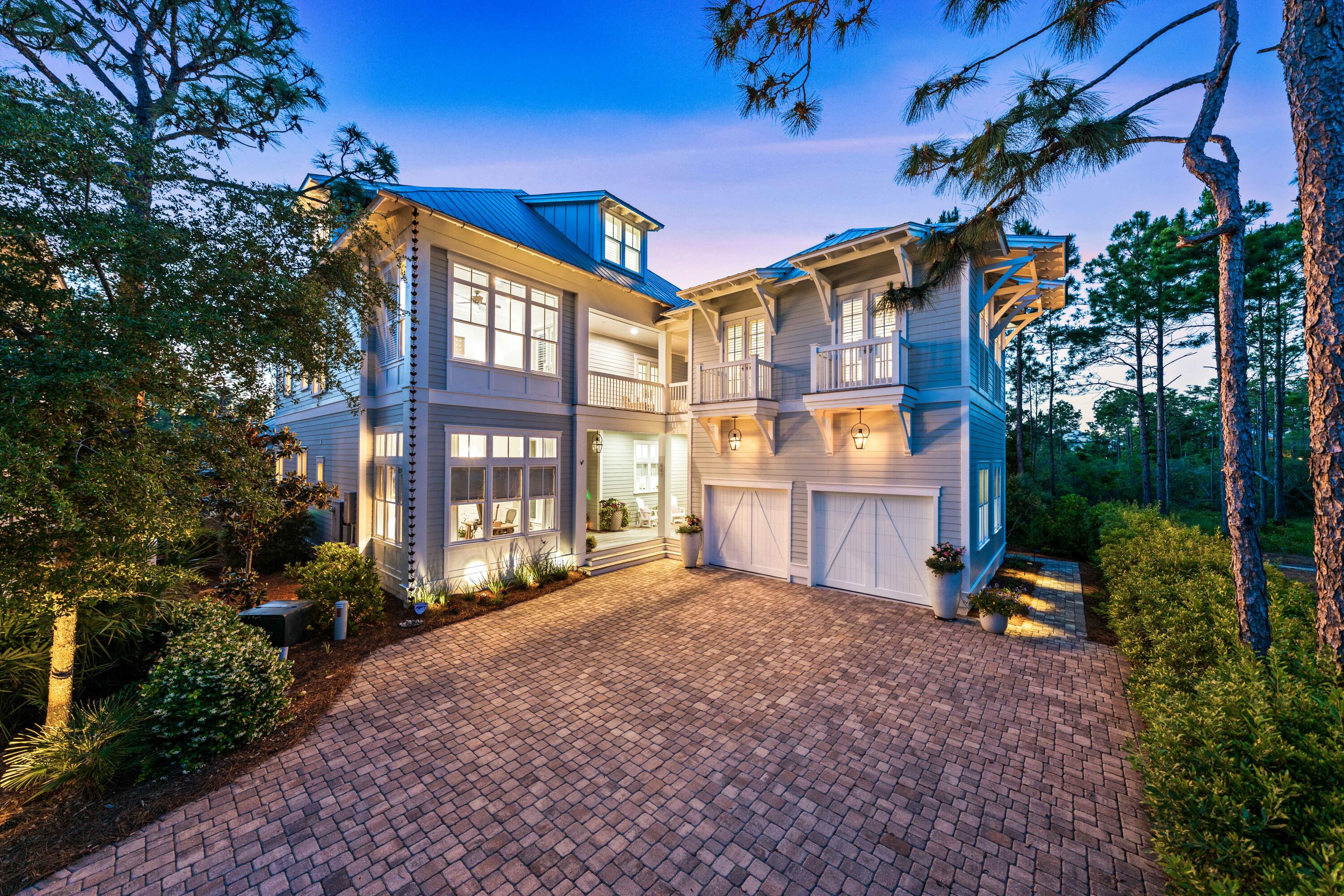 Thoughtfully designed and meticulously crafted, this stunning home at 667 E. Royal Fern Way sits on one of the most private lots in Watercolor, the premier planned community on 30A. Perfectly positioned to take advantage of common ground on three sides, a native forest provides the ideal backdrop for outdoor living. The chef's kitchen features premium Wolf and Subzero appliances, an oversized island ideal for food prep, serving, or casual dining, and a spacious walk-in pantry. Both the center entrance hall and kitchen flow seamlessly into the living and dining rooms that are each anchored by a fireplaces. Adjacent to the kitchen, the laundry room includes an office and convenient exterior access to both the rear and front porches. With its sitting, dining, and grilling areas, the screened porch is perfect for alfresco dining and entertaining. It opens onto a breathtaking pool deck, complete with a heated pool that boasts a waterfall and gas fire bowls. A cozy sitting area, enhanced by a fireplace is the ultimate spot for relaxation. The first-floor primary bedroom is a luxurious retreat with walk-in closets, a generously sized bathroom and direct access onto the pool deck. The climate-controlled wine storage and tasting room is a standout feature, designed to accommodate more than 1,500 bottles with space for tasting experiences. There is a private office and a full bathroom off the front entrance hall. The second floor is equally impressive, boasting three ensuite bedrooms, and a family room with a coffee bar, perfect for entertaining or unwinding. A second-floor carriage house provides additional private living space for guests. The third floor offers versatility with a spacious bonus room and an additional bedroom. All floors of the home are accessible by either the central staircase or a convenient elevator. Every detail of this home, from the warm wood flooring to the special upgraded finishes, enhances its ambiance and timeless sophistication. This distinctive home blends elegance and functionality to create an extraordinary living experience. When not immersed in the privacy of the home, take advantage of the many amenities Watercolor has to offer. Visit the beach club, one of four neighborhood pools or the town center with it shops, cafes and restaurants.  Offered furnished with some exclusions. Buyers to verify all information and dimensions.
