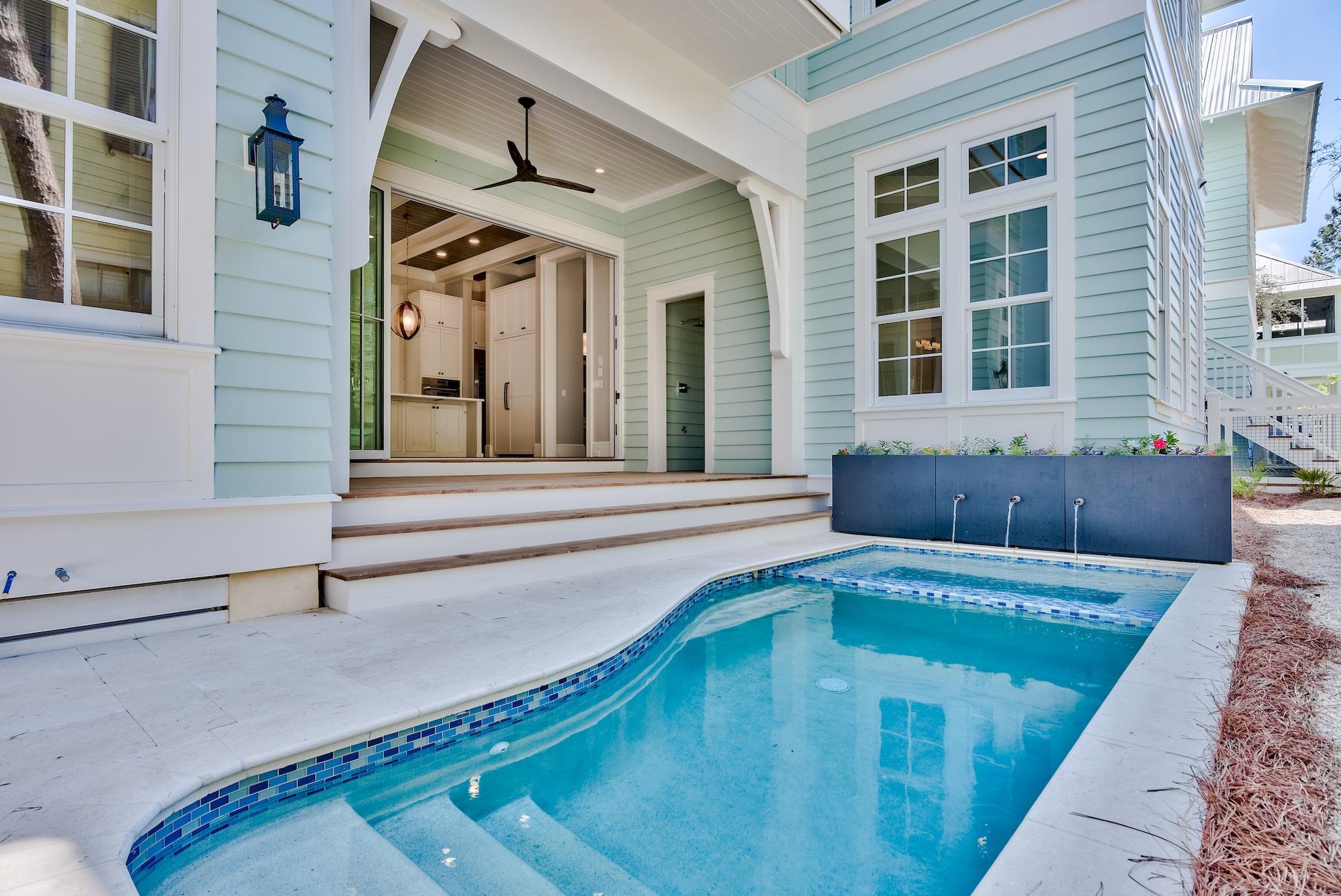 Set back in Watercolor's coveted phase three, this newly constructed 6-bedroom, eight bath home with elevator offers unrivaled quality. Throughout the home, the flow of the floor-plan, distinct custom finishes, statement tile, beamed ceilings, and stunning 5-1/4'' hardwood floors are evidence of master architect Gregory Jazayeri stunning design.
Crossing the wide porch to enter the home, the flicker of the gas lanterns beckon guests to come inside. This Watercolor home offers a coveted main floor master retreat, third-floor bonus bunk room with fun and functional flex spaces on each level. Large windows throughout the home's interior are wrapped in wide trim, bathing the room in natural light. The 12' soaring ceilings pull the eye upwards, as coffered ceilings and inlay tongue and groove welcome you into the space.
 
The warm wire-brushed oak hardwood floors lead you to the heart of this 5,203 square foot home, where you will find an expansive coastal kitchen with a large knotty alder wooden center island, elegant designer custom cabinetry, an expedient pantry, and breakfast bar, providing the perfect backdrop to entertain. A suite of Thermador appliances and full size wine fridge, draped with the stunning quartzite countertops, completed the kitchen. The open concept great room creates an ebb and flow between the dining and living area complete with a gas fireplace and ample space for family gatherings or corporate retreats. Fusing indoor and outdoor living, a hinged Euro-wall reveals a well-lit sun porch just beyond the kitchen, featuring a beautifully appointed exterior living area where guests can enjoy alfresco dining year-round in the outdoor kitchen including a 30" gas grill and leads you to the private, heated pool & spa. 
 
On the first floor, a master suite with a dedicated bath and a large walk-in closet. A guest suite with a private bath on the second floor, as well as a large sitting room and oversized laundry room. The 2nd-floor master suite provides spacious accommodations that offer a luxurious master bath featuring dual vanities, a walk-in shower, and a separate soaking tub. The master suite is equipped with a roomy walk-in closet and direct access to a private 2nd-floor porch. An expansive third-floor bunk room offers the ideal retreat after a day at the beach, while the adjacent media room & wet bar provide a comfortable area to watch the big game or most recent movie premiere. Across the walkway from the main home is the one-bedroom carriage house with a full kitchen and large sitting area, offering privacy for guests or family. A two-car garage, additional guest parking, outdoor shower, and golf car parking completes the residence.
 
Watercolor is home to pristine beaches, world-famous amenity-rich 60-room Gulf-front Inn, renowned golf courses, beach club, resort pools, and acres of gardens and footpaths. Within walking distance to Seaside, Watercolor is truly the gem of the Emerald Coast.