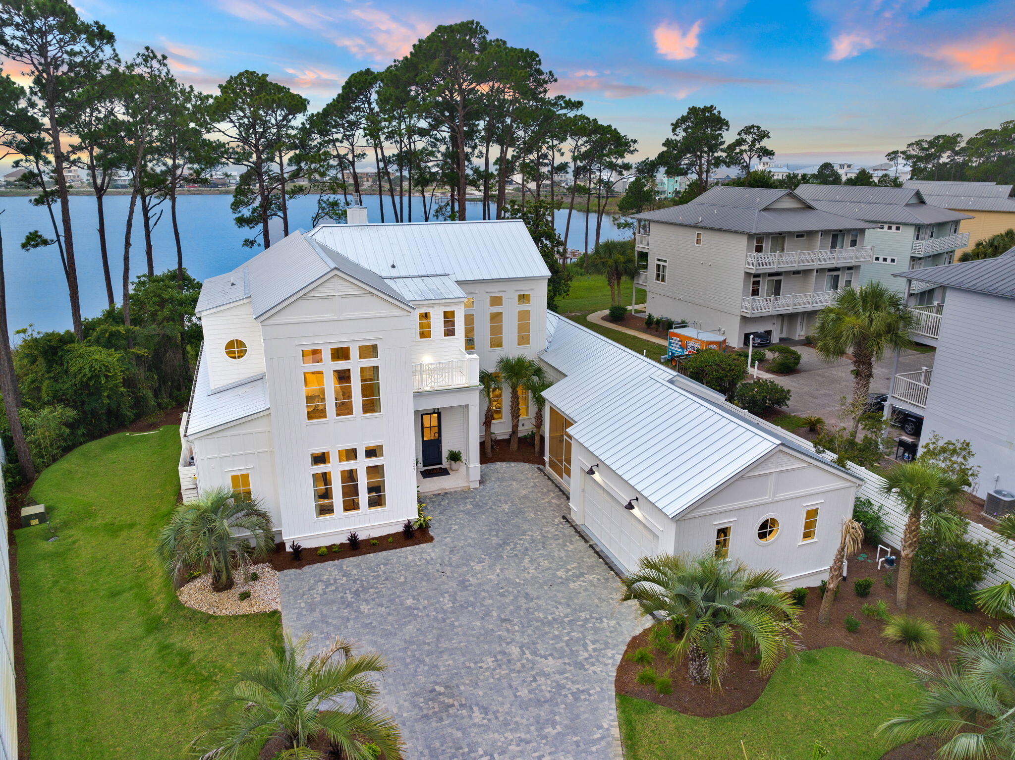 Welcome to this magnificent new construction home in Dune Allen Beach. Nestled on the serene Oyster Lake, this fully furnished gem offers over 4000 Sq ft. of pure luxury. With meticulous attention to detail, it boasts five bedrooms, four full baths, and two half baths, providing ample space for relaxation and entertainment.

Perched on a rare Coastal Dune Lake, the home enjoys a prime location with a large wooded lot surrounding it. As you step onto the property, you'll be greeted by a private swimming pool and spa, beckoning you to unwind and soak up the Florida sunshine. Imagine leisurely evenings spent on the expansive patio, complete with an outdoor kitchen, perfect for hosting unforgettable gatherings. The heart of this home lies in its gourmet chef's kitchen, featuring top-of-the-line gas appliances that elevate your culinary experiences. Indulge your inner chef and create delectable meals for friends and family to savor.

The first floor is a haven of tranquility, featuring a generously sized primary ensuite with two walk-in closets, a private bath, and even a secluded outdoor shower for those seeking a refreshing escape. The open-concept design encompasses a spacious living room, a dining area, a wet bar, and a gas fireplace, all seamlessly blending together for effortless entertaining. Additionally, a well-appointed bunk room with a private bath provides versatile accommodations for guests.

The 2-car garage boasts a high-end epoxy floor coating, ensuring easy cleanup after enjoyable beach adventures. Ascend to the second floor, where you'll discover two junior primary bedrooms, each with their own private baths and walk-in closets. An additional lounge and game room area await, featuring custom-made queen over queen bunk beds for both relaxation and amusement. Step out onto the expansive second-floor patio, an idyllic setting for mingling and relishing the coastal breeze. And for the ultimate sunset viewing experience, make your way to the third-floor lookout deck, where nature's beauty unfolds before your eyes.

Privacy is of paramount importance, and the driveway offers the potential for an upgraded gate, granting an added layer of seclusion to this remarkable oasis.

This home, crafted with impeccable taste and a devotion to coastal luxury, epitomizes the 30A lifestyle. With its unparalleled lake and Gulf views, unrivaled amenities, and a location that showcases the beauty of the Florida coast.
