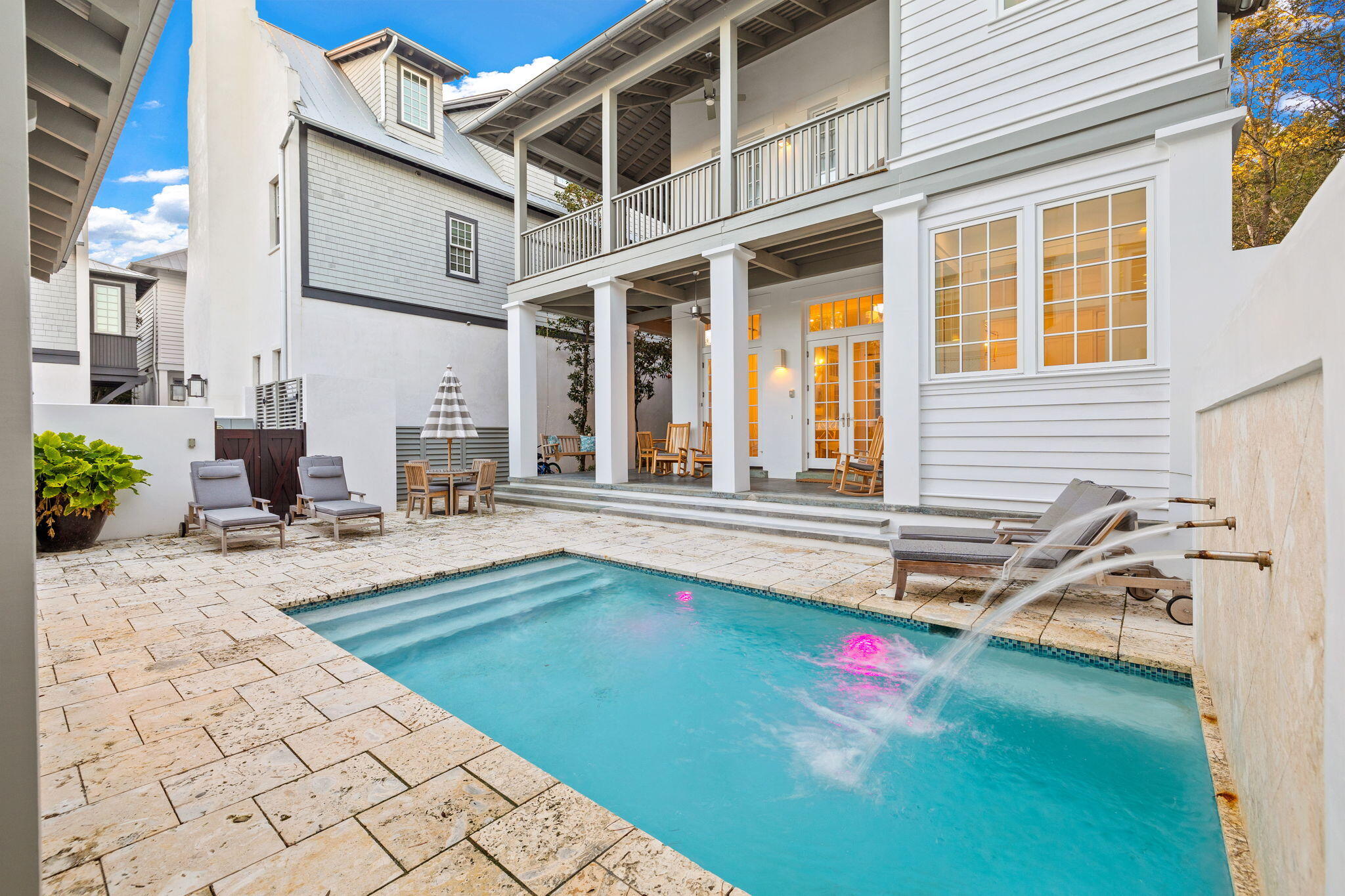Introducing a stunning property situated on Rosemary's Southside, this recently renovated concrete home offers an exceptional living experience. With meticulous attention to detail and stylish furnishings, this residence exudes elegance and tranquility. Whether you seek a primary residence, a vacation retreat, or a lucrative rental investment, this home is perfectly suited.

Featuring a well-designed floor plan, the main house boasts five bedrooms, two living areas, and expansive porches totaling nearly 1,000 square feet. The open kitchen caters to gourmet enthusiasts, equipped with convenient features like a filtered water tap, instant hot water dispenser, and a Scotsman Nugget Ice Machine. The first-floor living area showcases French doors that frame stunning views of the pool and courtyard.

Designed for entertaining, the spacious living area seamlessly transitions to a private courtyard. Enjoy ample porch space, a large heated pool with a captivating water feature, a new summer kitchen, an indoor/outdoor half bath, and an outdoor showerideal for hosting gatherings and creating lasting memories.

A detached two-story carriage house provides flexibility, featuring a full kitchen and a private bedroom. This space is perfect for accommodating overflow guests or as its own separate peaceful retreat. Parking is convenient with a spacious two-car garage and additional dedicated spaces.

Step through the impressive Mahogany doors and find yourself on a beach walk that leads directly to the pristine, white sands and crystal-clear waters that define this extraordinary location. Take advantage of the central position, with access to Rosemary Beach's renowned shopping and dining destinations.

With modern upgrades including tankless hot water heaters, self-regulating humidifiers, whole-house air purifiers, and permanent filters in the new AC units, this home offers both comfort and convenience.