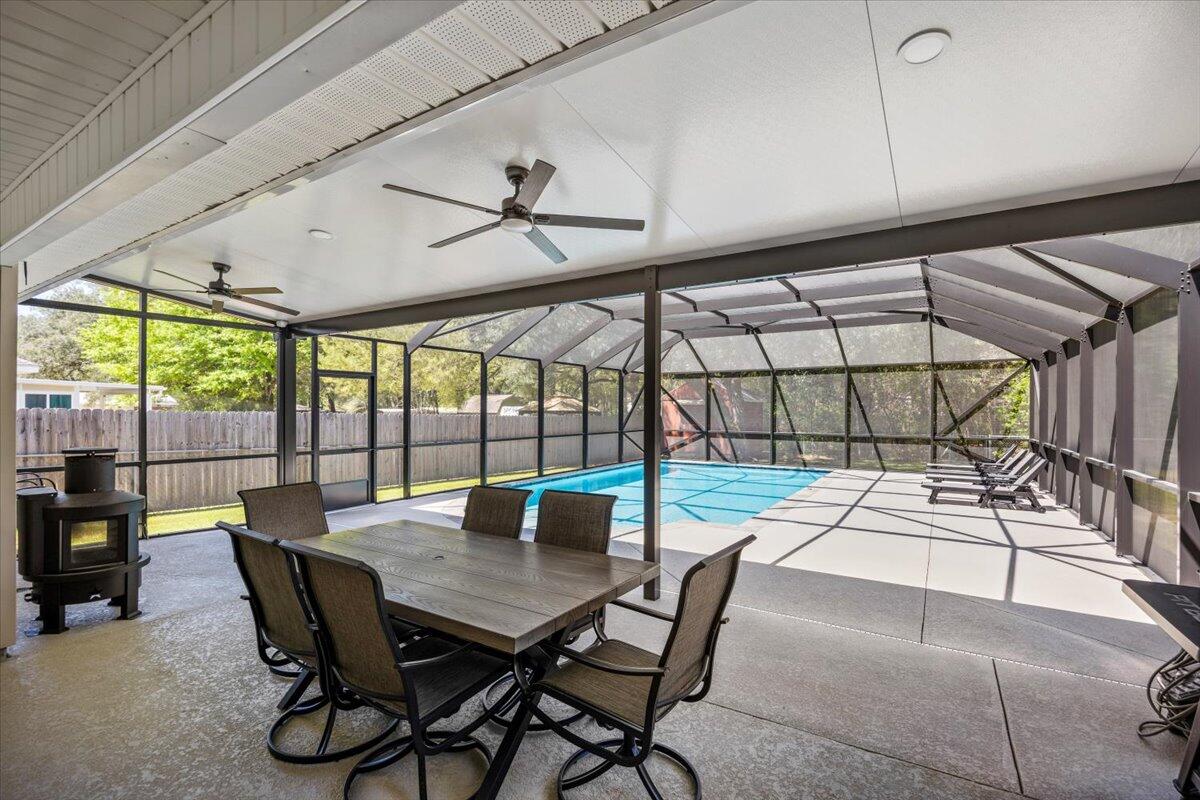 Step into this inviting 3-bedroom, 2-bathroom home, where comfort & charm blend effortlessly. The fenced backyard is a private retreat with a sparkling inground screened-in pool & patio—perfect for summer gatherings or peaceful mornings. Inside, the open floor plan flows beautifully, featuring a spacious great room with soaring ceilings, a lighted fan, & elegant plant ledge. The kitchen is a chef's dream with generous counter space, a large pantry, & a cozy breakfast nook filled with natural light & backyard views. The primary suite offers a sitting area, trey ceiling, patio access, & a spa-like bath with a garden tub, double vanity, & walk-in closet. Easy access to shopping and Whiting Field. See the full list of upgrades and make it yours!
