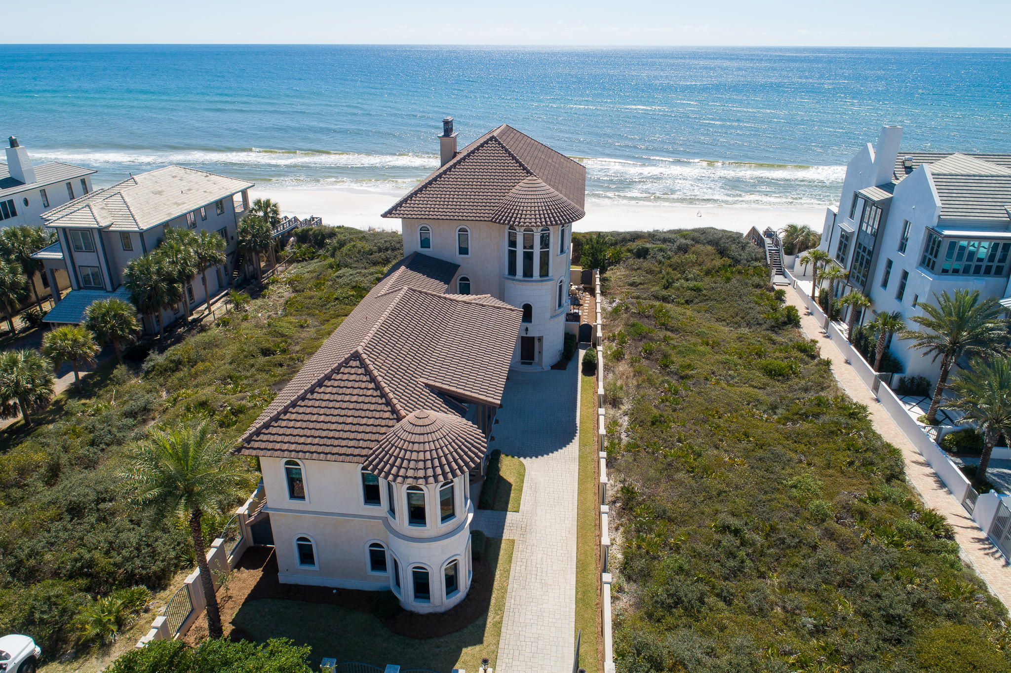 The culmination of meticulous craftsmanship & materials from around the globe, this 7-bedroom, 10-bath Mediterranean estate is a work of art in prestigious Paradise by the Sea. Designed by renowned architect Darrell Russell of A Boheme Design, the home's grand volume is accented by marble floors, hand-applied Venetian plaster, and an elaborate three-story spiral staircase. Beautiful millwork, crown molding, arched windows, columns, and coffered ceilings can be found throughout the home's impressive 8,729 square feet.
The main living area takes full advantage of the unspoiled coastal views, providing the perfect backdrop for entertaining, corporate retreat or family gathering anchored around the gas fireplace. The adjacent media room offers an idyllic setting for a private screening of the latest motion picture release alongside an expansive bar & conditioned wine closet to display even the most distinguished sommelier's collection. Host a musical award celebration of your own in the music hall that includes a Yamaha Baby Grand Piano and seating area. A large chef's kitchen encompasses a granite-topped oversized island with a deep drop-in double basin sink and dishwasher. Other amenities include a Jenn-Air custom built-in refrigerator, Thermador 6-burner stove with double oven, and a substantial eating area. It is a true epicurean delight.

The private third-floor owner's suite offers a gracious foyer leading to the elegant master retreat atop the white oak hardwood floors. The suite includes a gas fireplace, private balcony overlooking the Gulf, large work-out room with equipment, two personal offices with water views and a spa-like master bath with walk-in shower & soaking tub. A private laundry, morning kitchen and lavish master closet with custom cabinetry complete the suite.  

Constructed with generational living in mind, this legacy home offers separate sleeping quarters, bunk room, private baths and secondary living area with kitchenette in the lower level north wing. A secondary master suite with spa-like en-suite offers a relaxing sanctuary with access to an oversized recreation area, private entrance and attached single car garage. 

Embrace the true Florida lifestyle, in the heated gulf-facing pool, or enjoy the coastal dune walkover to the private beach below before enjoying an evening meal at the outdoor kitchen oasis. From the foyer to boardwalk steps, this residence delivers endless opportunities to entertain family and friends in lavish comfort.  

Notable features of the home include elevator; gaming area & media room; laundry available on every level; private, gated home; 3-car garage with liberal guest parking available. 

Paradise by the Sea is a gated community located minutes from Rosemary Beach. With award-winning architecture, quaint shops, weekend Farmers Markets, and some of the area's most highly rated restaurants, Rosemary Beach is truly one of the greatest amenities available to residents & guests of Paradise by the Sea.
