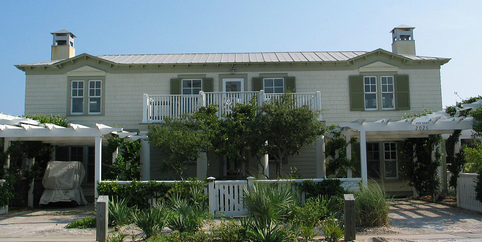 Located 2nd row south of Co.Hwy 30A Seaside, just 2 minute stroll to beach. Recent interior renovations include new kitchen w/white wood cabinetry, Carrera marble countertops, 6 burner Viking gas stove, Viking refrigerator & dishwasher. Master & guest baths have been renovated w/new showers, subway tiles & Carrera marble countertops & flooring. Addt'l updates include interior & exterior repainting & new HVAC's. 1 of 2 sets of stairs flank either side of foyer lead to second level. Living area w/sectional sofa is a the perfect place to cozy up in front of one of two fire places while watching your favorite movie on the flat screen television. Between the living and kitchen area is a light filled sitting area with a breakfast table which can double for afternoon board games. Two deep set open porches on the north & south side of cottage can be used for outside dining or catnaps.Access roof deck from south porch for sunbathing, dining or watching the spectacular sunsets over the emerald green waters of the Gulf of Mexico. The family chef will covet the new fully equipped kitchen with fireplace. Adjacent dining area is conveniently located across from the kitchen & accommodates a flat screen television & table for ten.  Downstairs are 3 bedrooms with en-suite baths and additional double bunk room. A laundry room & shuttered porch for storing beach toys after enjoying your fun in the sun are also on first level. This porch provides access to outside shower & spacious deck w/large family picnic table, barbecue & storage chest. Property includes two car carport. Furnished except art & some accessories.