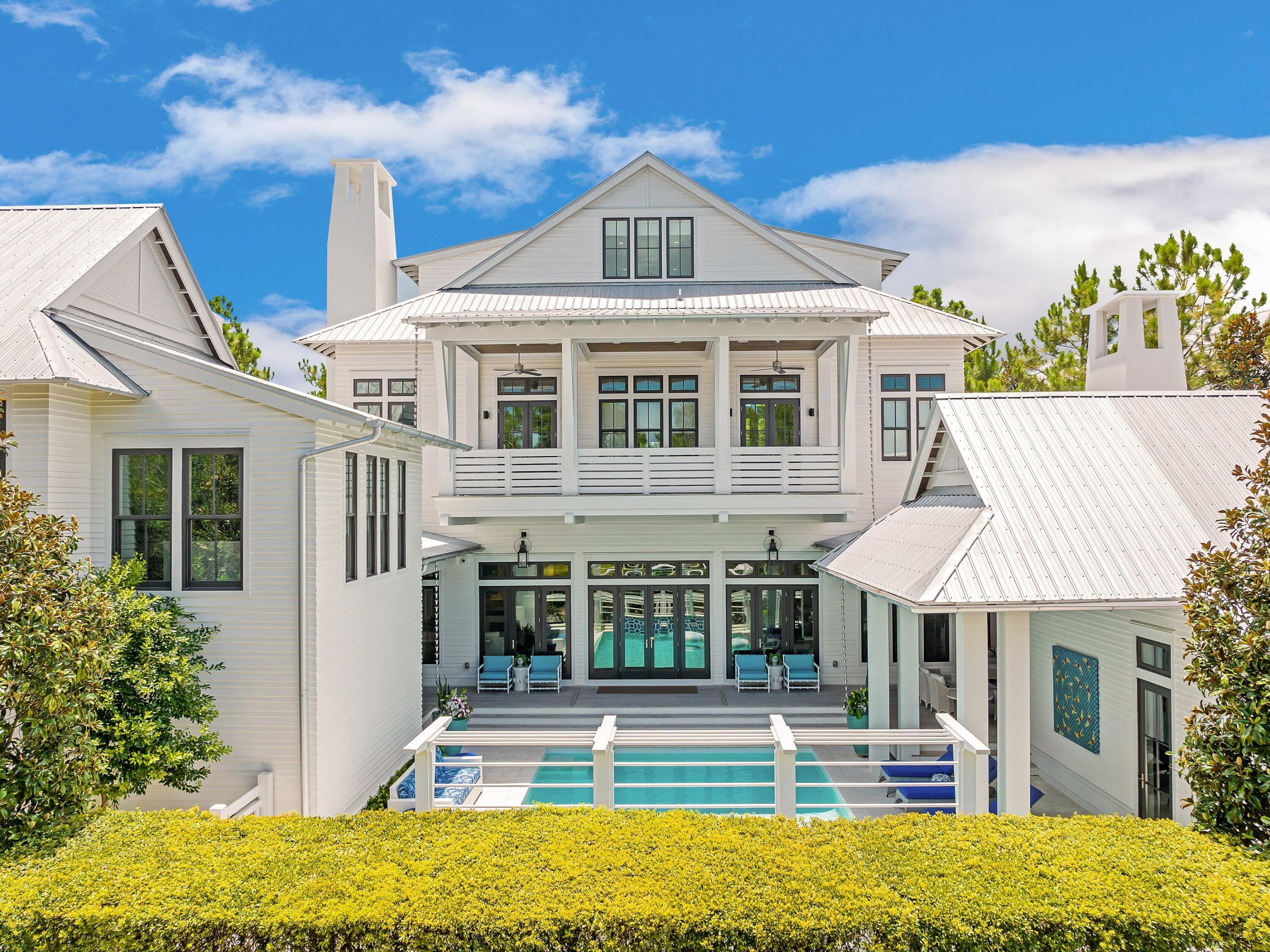 Positioned on one of the largest - if not the largest  - homesites in all of WaterColor and thoughtfully brought to life through a collaboration between renowned architect Geoff Chick, the homeowner, and Cara Richardson of award-winning Lovelace Interiors, 191 Sand Hill Circle is a residence defined by intentional elegance, architectural integrity, and elevated livability. Framed by a peaceful pocket park in front and the preserved beauty of the state forest behind, this 8,314-square-foot estate stands as one of the community's true masterpieces. Every detail of this seven-bedroom, seven-and-a-half-bath home has been artfully curated, from Venetian plaster walls to a whole-home Control4 system that manages lighting, sound, climate, and security. Custom artisan lighting, curated furnishings, and dramatic accents, such as original works by award-winning artist Mary Hong, create a home that is both visually striking and deeply livable. Each bedroom features an ensuite bath with dual vanities, custom tile from Q-Tile, and high-end, bespoke bedding.

The chef's kitchen is outfitted with Wolf and Sub-Zero appliances, complemented by a butler's pantry with a second oven and dishwasher. Three laundry rooms ensure effortless convenience, while the owner's retreat  secluded on the second level  features electric drapes, serene views, and access to expansive porches.

Outdoor living is equally refined. The resort-style pool is flanked by two covered pavilions: one side features a fully appointed outdoor kitchen and grill, while the other boasts a posh gathering area complete with a fireplace and TV. A full pool bath and lush, irrigated landscaping complete the setting, enriched further by elegant rain chains and peaceful sightlines.

The home also features a posh carriage house above one of two climate-controlled two-car garages, making it the only residence in WaterColor to offer this level of vehicle and guest accommodations, along with two additional parking spaces. Blending art, technology, and lifestyle  and offered mostly furnished, including a GEM car and two electric bikes  this exceptional property was honored as the cover feature in Florida Design Magazine. This is not just a home; it is WaterColor's most exquisitely crafted residence and a once-in-a-lifetime opportunity to own a true generational estate on 30A.