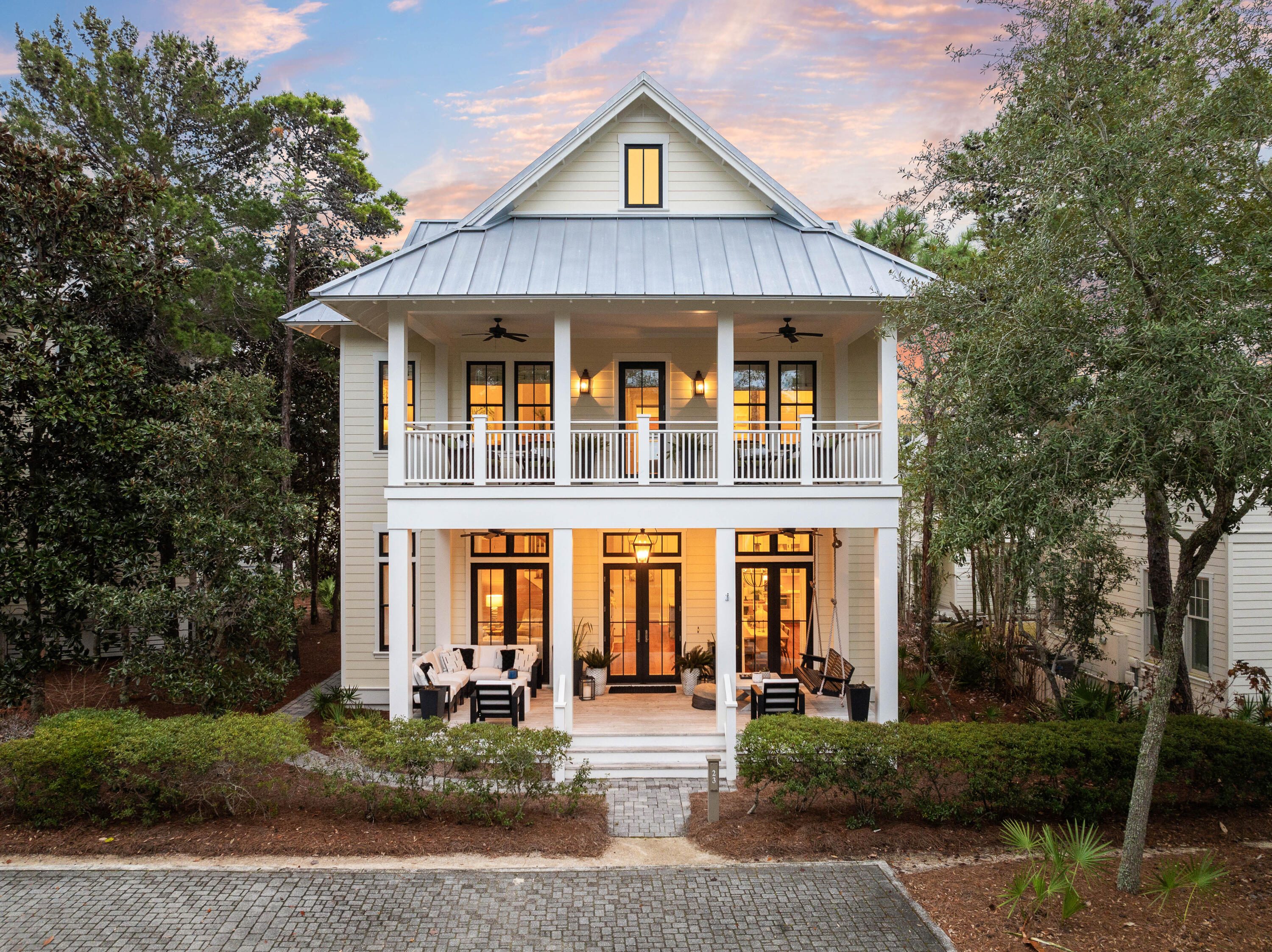 Welcome to WaterColor Phase III, where this stunning beach house embodies the best of the Sand Hill lifestyle. Ideally situated near the beloved Frog Pool at Sandhill Circle, this luxury residence is one of just 24 homes in the neighborhood, offering access to a community pool and a charming pocket park. Set back from the paved street, the home welcomes you with an expansive covered front porch, perfect for unwinding with a refreshing drink on balmy coastal evenings.

Inside, tall, bright rooms with soaring ceilings create a spacious and sociable atmosphere, while fresh paint and stylish furnishings make this an attractive investment opportunity. The main sitting room features beautifully crafted wooden shiplap walls and durable LVP flooring that extend into the formal dining area. The seamless open floor plan invites effortless entertaining and memorable gatherings, whether you choose this as a vacation retreat or a permanent residence.

At the heart of the home, the open-concept kitchen is both sophisticated and functional, centering around a marble-topped island with a farmhouse sink, a Sharp microwave drawer, dishwasher, built-in wine rack, and seating for four. Elegant glass-front cabinets with display lighting provide ample storage, complementing the stainless steel appliances, vented hood, and Thermador six-burner gas range. A gleaming subway tile backsplash adds a timeless touch to the space.

A rear hallway leads to a convenient half bath and continues into a well-appointed mudroom with a laundry area and sink. Beyond, a glass door opens onto a covered wooden deck with steps leading to a paved barbecue terrace, creating the perfect setting for alfresco dining and outdoor entertaining.

Five exquisite bedrooms offer comfort and tranquility, including a first-floor primary suite complete with a private ensuite featuring a twin vanity, a tiled walk-in shower, and a luxurious soaking tub. French doors open directly onto the porch, inviting gentle coastal breezes. Upstairs, a thoughtfully designed layout includes a large bunk room with two sets of twin bunks and a sleeper sofaideal for hosting guests. The king-sized primary suite boasts its own lavish ensuite with a garden tub, separate shower, and an extended double vanity. A Jack-and-Jill bathroom conveniently serves the third bedroom and is accessible from the upper hall, while the fourth bedroom is a bright, inviting space with doors opening onto the wide upper balcony, perfect for serene mornings and treetop views.

The home's exterior is equally impressive, featuring a covered parking area, bike storage, lounge chair storage, and an outdoor shower for rinsing off after a day at the beach. Additionally, the property offers ample room to add a carriage house and a private pool, enhancing its appeal as an ultimate WaterColor retreat.

Just a short golf cart ride from community pools, a fitness center, jogging trails, and the private beach club, this home offers easy access to all the best amenities of WaterColor. Ride your bike to Seaside for boutique shopping and oceanfront dining, or explore Western Lake by kayak or paddleboard, immersing yourself in the beauty of Florida's rare coastal dune lakes. Surrounded by nature, world-class dining, and some of the most pristine beaches in the country, this exceptional home presents a rare opportunity to experience the best of 30A living.