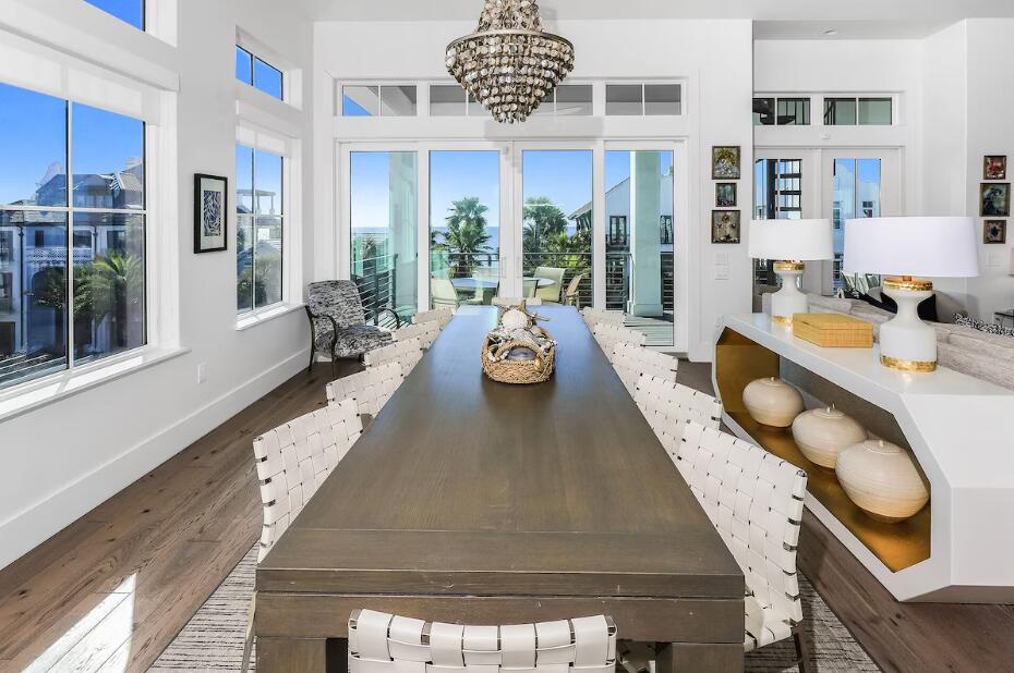 Discover unparalleled elegance in this luxury home located on 30A, nestled between the renowned Surfing Deer and Seaside. This exceptional Seagrove Beach property boasts breathtaking panoramic Gulf views and a remarkable rental income grossing up to $320,000. Encompassing over 5,200 square feet of meticulously designed living space, along with an additional 2,500 square feet of inviting porches, this six-bedroom, five and one half bath haven is across from the Live Oak Beach access.

Step inside and experience the exquisite modern interiors, accentuated by tasteful designer finishes that create a seamless blend of sophistication and style. 

The first level features a game room that opens to a stunning lanai accentuated with a fireplace, outdoor grill, and heated saltwater pool, and full pool bath. 

Experience the timeless elegance of an exquisite travertine pool deck, elegantly surrounded by an abundance of palm trees that enhance your privacy. This luxurious outdoor oasis invites relaxation and tranquility, making it the perfect retreat for sun-soaked days and starlit evenings.

The bunk room, accommodating four, includes two sets of full/full bunks with a private ensuite  bath. 

The second floor is dedicated to the owner's retreat, complete with a walk-in closet and a luxurious private bath featuring a shower, dual vanity, and a soaking tub with Gulf of America vistas with balcony access overlooking 30A. Three additional bedrooms, one with gulf views and balcony, ensuite baths, and second laundry area adds convenience.

Ascend on the elevator to the third floor with a sleek wet bar equipped with a wine refrigerator and ice machine. The gourmet kitchen showcases a dynamic quartzite island, Wolf appliances, including a double gas range, exhaust hood, dual dishwashers, SubZero refrigerator, and convection oven overlooking the elegant dining area with endless gulf views. 

Enhancing your outdoor living space are dual euro doors creating an outdoor entertainment oasis with room for outdoor dining or overflow guests.

The crowning glory is the fourth level rooftop sun deck, offering breathtaking 360-degree views of the Gulf, ideal for sunrise and sunset memories of a lifetime. 

The sixth bedroom with a king bed and ensuite bath completes the third floor, with a half bath for guests. 

Exquisitely appointed and offered fully furnished with elegant hand screen-printed wallpaper, custom tile and fixtures hand picked in each space fulfills the sophisticated palette.

For those who prioritize living and vacationing along 30A, this home offers walking 150 feet to the scenic Gulf of Mexico and Seaside; perfect for the avid beach connoisseur seeking the luxury 30A lifestyle.