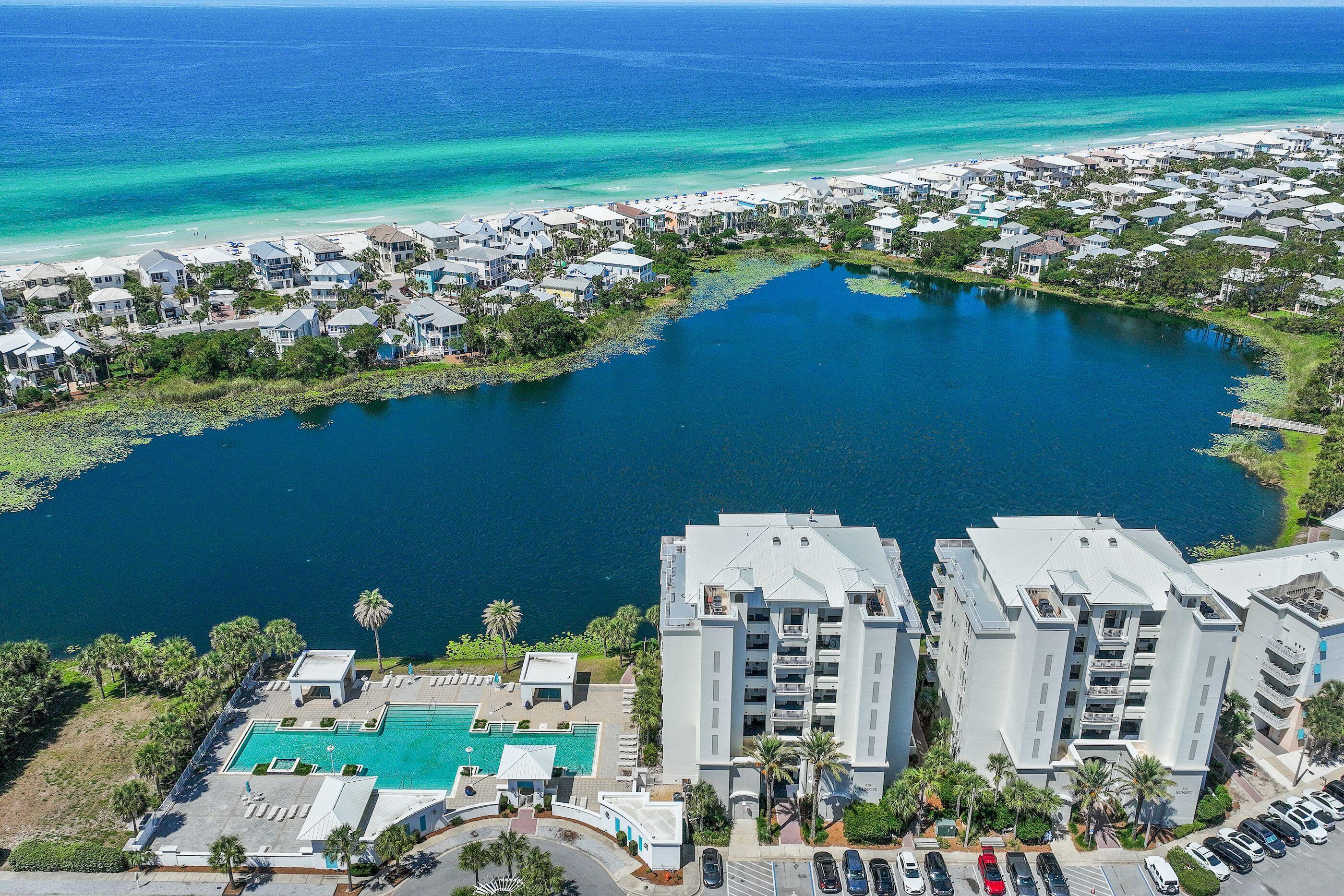 This is the perfect family vacation retreat or Investors' rental dream! Short Term Rentals are allowed.
This coastal contemporary Penthouse with 4 bedrooms, 4 1/2 baths and 3,623 sq ft spans the entire top level of a small 7-story, recently renovated condo building and features a wraparound balcony with unmatched panoramic water views throughout of the Gulf, Lake Carillon and Lake Powell. It's located in the charming, vibrant, gated, community of Carillon Beach which is about 2 miles East of Rosemary Beach. You can stroll to  the private, pristine one mile beach in just 4 minutes  or relax in the nearby pool with spa. It was completely redone in 2024 with a renovated in 2004 with a stunning high-end remodel including new windows, appliances and furnishings. There's an elevator entry into a private foyer to Unit 701. The open concept living area with high beamed cailing, large great room with gas fireplace, wall of glass doors and windows, and a spacious dining room combines the upscale chef's kitchen with island, long breakfast bar and top-of-the-line appliances. The two Master suites also access the balcony with expansive water views, luxurious baths with soaking tub and walkin showers and large walk-in closets. There is a guest room with four, full size bunk beds and private bathroom with tub. It opens onto the wide balcony offering views of Lake Powell. The second guest room with balcony access features a large closet and luxurious bath with a walk-in shower. There is also a powder room and spaciious laundry room with plenty of cabinets. This Penthouse is  ''one of a kind'! It is the perfect family or corporate retreat or rental investment!