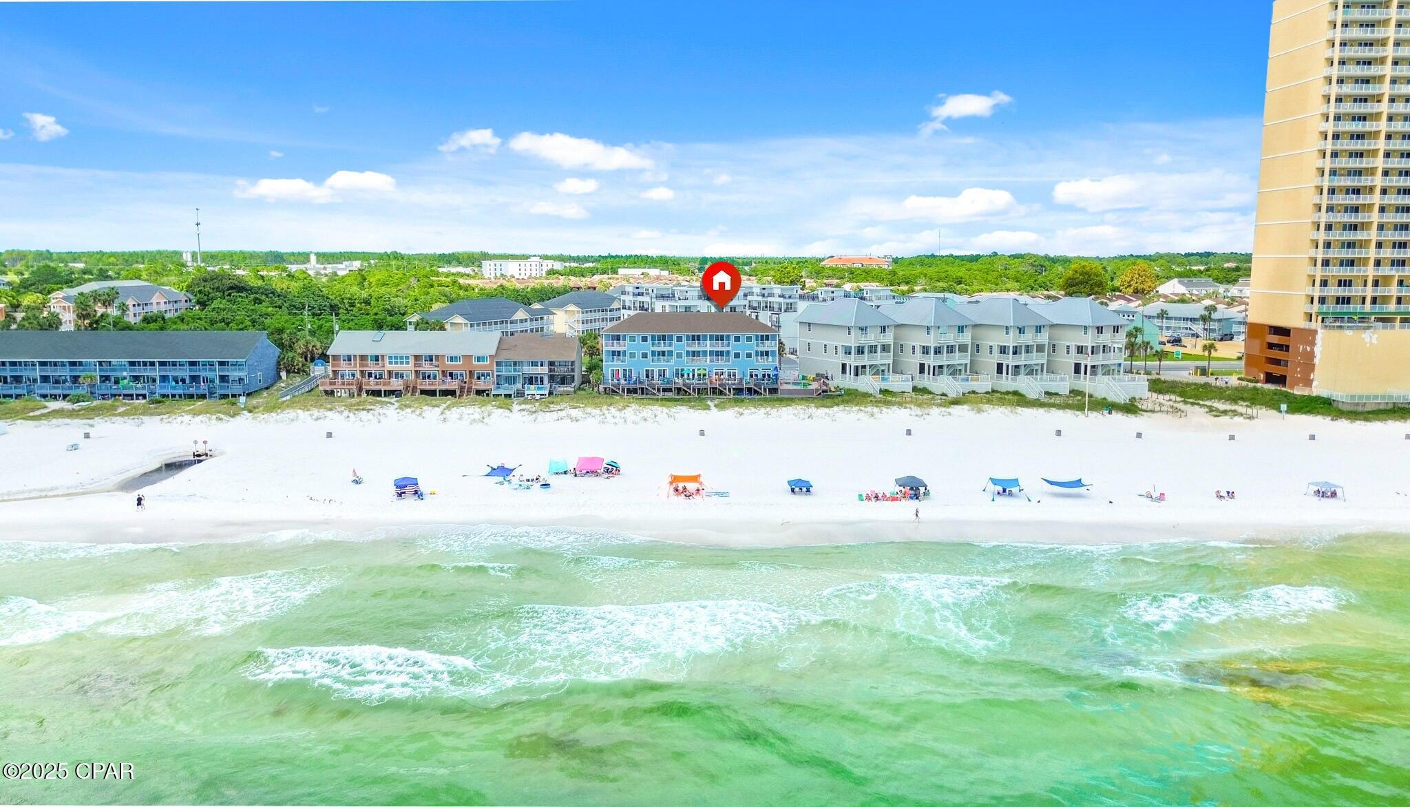 Imagine waking up to the sound of waves crashing just steps from your door, sipping coffee on your private balcony as dolphins play in the surf, and ending your evenings with breathtaking sunsets over the Gulf. This is the lifestyle awaiting you in this rare 3-story Gulf-front townhome, that truly feels more like a private beach home. Experience true Gulf-front living with over 2,200 square feet, 4 spacious bedrooms, and 4.5 baths, designed for both relaxation and entertaining. The main level features an open concept with high ceilings, crown molding, and freshly updated LVP flooring. A well-appointed kitchen with granite countertops, stainless steel appliances, and plenty of cabinetry flows easily into the dining and living areas, where double sliding doors open to an expansive Gulf-front deck. A wet bar with wine cooler adds the perfect touch for entertaining. On the second and third floors, you'll find two Gulf-front master suiteseach with private balconies and spa-like baths featuring large tubs, separate showers, and new vanities. An additional oversized en-suite bedroom provides space and comfort for family and guests. Every upgrade has been thoughtfully handled, including hurricane glass film protection on doors and windows, new Trex decking, fresh exterior paint, and updated HVAC systems. The exterior has undergone extensive replacement and waterproofing, ensuring durability and peace of mind. Step outside to enjoy the private Gulf-front pool shared by just five units, or take your own stairs down to the white sand beach. Perfectly located in the heart of Panama City Beach, you'll be just minutes from the best shopping and dining at Pier Park, family attractions like Top Golf and Pirates Voyage Dinner & Show, and only 15 minutes from the airport. This property is ideal as a luxury residence or a strong vacation rental investment. With 2 assigned parking spaces, 3 additional overflow spots, excellent rental history, and solid financials, this is a turnkey opportunity you won't want to miss. This condo is made to provide ample space and sleeping for large families! All engineering inspections have been completed as per new condo rules!! This rare opportunity combines low-density living with breathtaking Gulf views and modern updates throughout. Schedule your private showing today and start living the Gulf-front lifestyle you've always dreamed of! Rental income for 2025 is over $88,000.00 with no rentals for January and February due to HOA repairs.