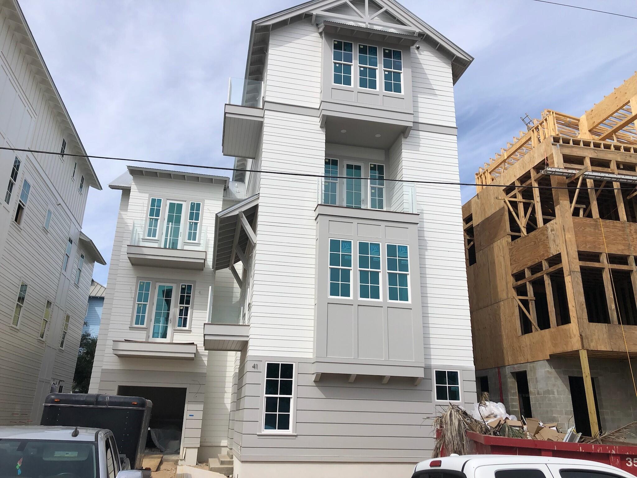 Location, Location, Location!! This brand new 4 story home within walking distance to Seaside Development on 30-A is a great home for rental or large family gatherings.  Glass lanterns, 200 year old wood beams in living and master bedroom, shiplap walls, custom iron railings, tempered glass exterior railings on balconies, Italian marble (Calcutta Gold and White Carrera) in every bathroom, hardwood floors and so much more! 
A large pool is  half covered and half open. 
The third floor master is complete with on- suite including a free standing soaking tub, double vanities and large shower.  Kitchen has designer cabinets.  A bunk room has it's own private bath and common area.  Fourth floor has media room, amazing Gulf views and large deck for entertaining with wet bar and beverage fridge.