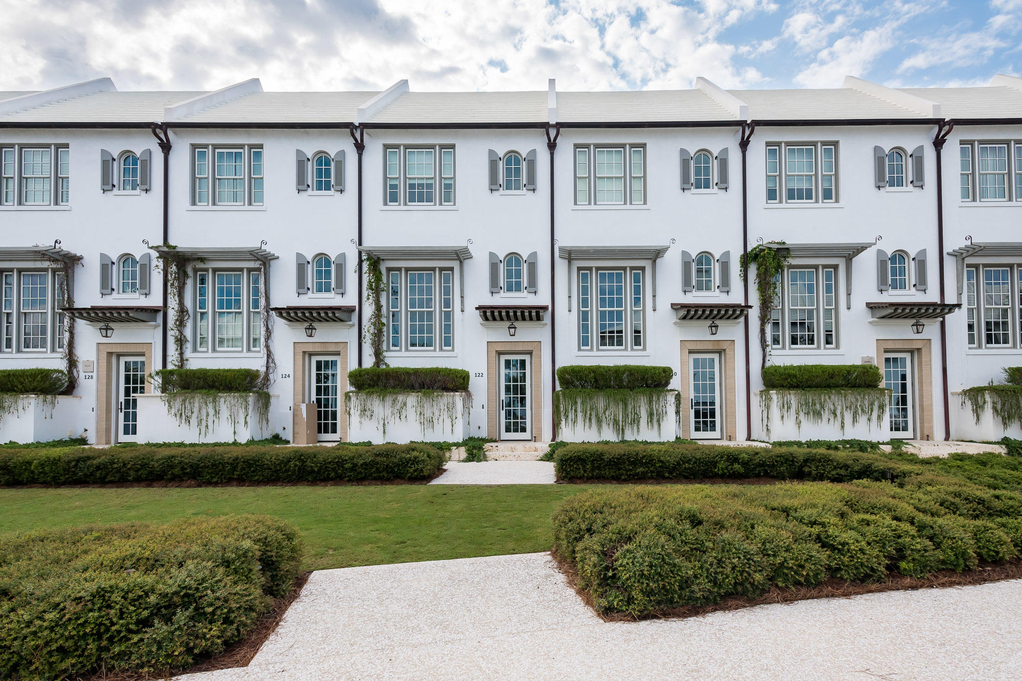 Caliza Courts residence 122, sited just south of Caliza Pool, forms a welcoming addition to Alys Beach. Designed by Khoury & Vogt Architects, the home is graced by a fronting park along N. Somerset Street, with a raised stoop entry bordered by landscaped planters. The entry and stair hall ushers one into the main living area rising one-half a floor above grade. Spanning the width of the homesite, the great room has 16-foot ceilings with 12-foot doors and windows that open to a private courtyard oasis bringing warm light into the home. Dominican Shellstone flooring carries throughout the main living levels then transitioning to the private outdoor gathering locations.  Across the courtyard is an open-air furnished loggia with upgraded SunBrite television for outdoor entertaining looking into the courtyard to the main home. This loggia leads you to the 3rd bedroom that is a detached guest allowing for guest privacy with garage below. The home's kitchen features custom, Rift Sawn Oak Cabinetry stained soft gray, Blizzard White Caesarstone countertops with an intermittent pattern of mosaic Halsa honed marble backsplash.  Thermador Appliance suite completes the kitchen. The second and master bedrooms, both located in the main home, each occupy their own half floor, maximizing privacy, with the master suite sitting above the tall great room. The 2nd bedroom has an en suite bathroom and closet lending itself to children or guests. The gracious master uniquely has its own private entry hall with custom shelving prior to arriving in the bedroom.  Upon entering, your eyes are drawn to the Eastern window bank pulling light through the room warming the furnishings.  Warm & spacious, the master hosts 4 closets to accommodate extended visits or owner closets should the owner elect to rent the home. 122 N. Somerset is strategically located centered in Alys Beach with amenities surrounding the property.  From the front lawn, you are steps to Caliza Pool, Town Center, Zuma Wellness Center, and the private owners Beach Club.  This property is a must see.