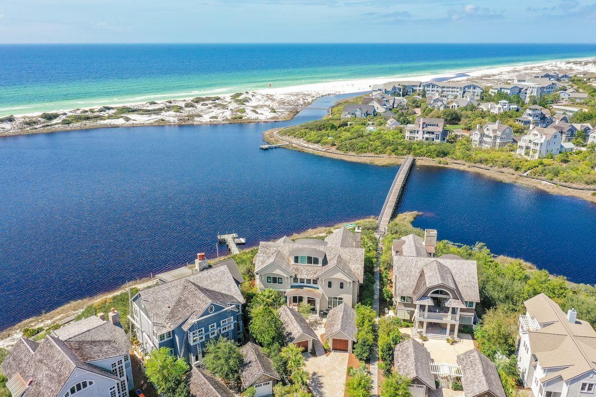 Within the gated enclave of Watersound Beach, this spacious 5 bedroom home enjoys stunning lake and gulf views with expansive porches. Meeting the needs of the most discerning buyer, this home has a main house, carriage house, 2-car garage, private elevator, large resort size pool and crows nest! The first floor hosts 3 bedrooms including a large bunk room, screen porch and access to the heated salt-water pool and summer kitchen. The 2nd floor main living area offers views of the lake, fireplace and great space for cooking and entertaining along with a large walk-in pantry and Thermador appliances for the chef! The 3rd floor is exclusively the master suites with excellent closet space, office nook, remarkable lake and gulf views, private balcony and a spiral staircase to the crows nest. The carriage house is the perfect guest suite with bedroom, bath and kitchenette. The Watersound Peninsula offers community docks to enjoy kayaking and paddle boarding on Camp Creek Lake and easy access to expansive uncrowded beaches.