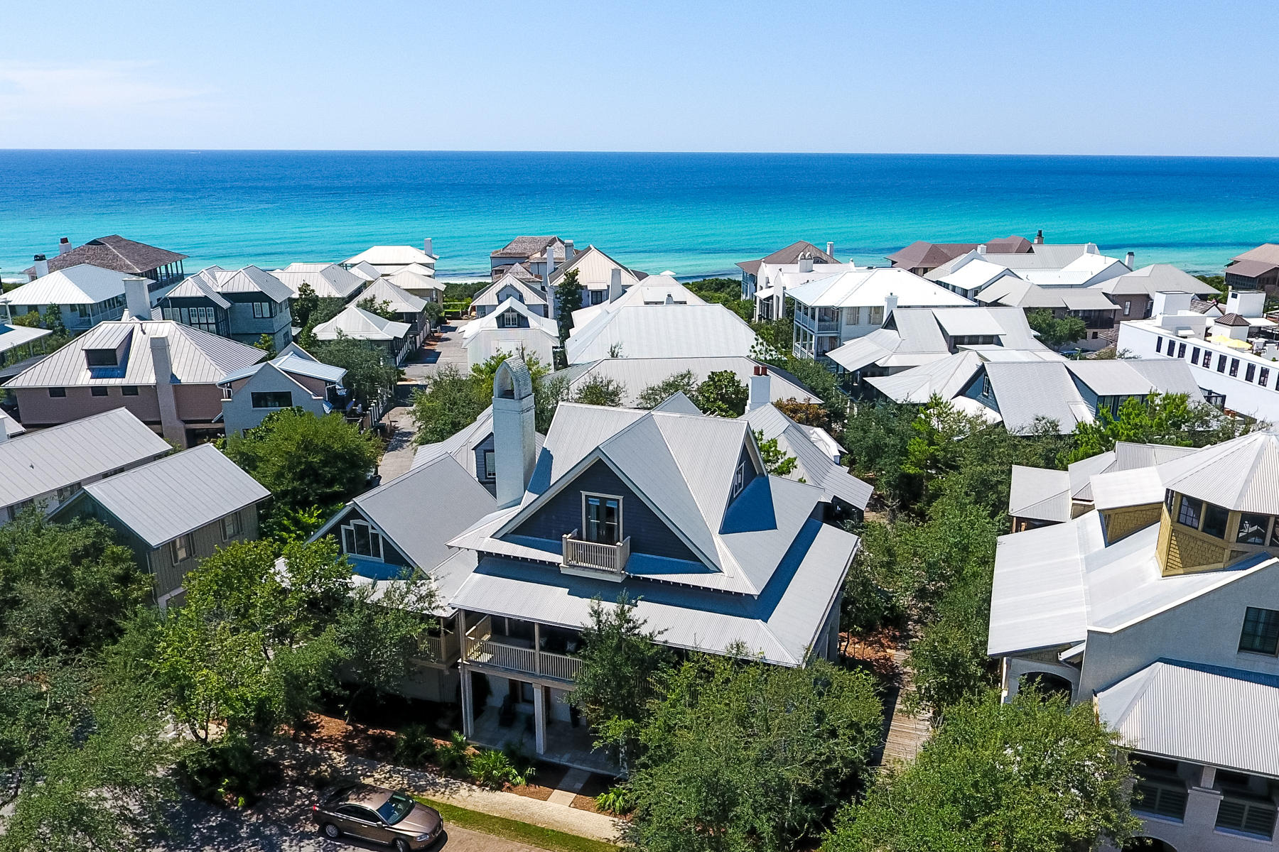 Nestled in the heart of Rosemary Beach, near the Town Center and a short walk to the beach, resides a recently updated 5 bedroom, 3 -1/2 bath main house, with 1 bedroom, 1 bathroom carriage house with loft. The open floor plan was designed on a grand scale, with entertaining and large families in mind. The ground floor consists of four bedrooms ideal for guests and children. Upstairs, the second level boasts an oversized family room with dining area and gourmet kitchen with professional stainless steel appliances, granite countertops and breakfast bar. A private master suite on the third floor opens to an outside balcony, a perfect location for soaking in the sun or enjoying the ocean breeze. The exterior of the home exudes antebellum charm with its pillared verandah and wrap around terraces on both the 1st and 2nd levels. The Sky Deck provides panoramic ocean views while the outside back courtyard has Moroccan inspired glass tiled dipping pool with waterfall. The carriage house, with wrap around porch, kitchen, sitting area, bedroom and upper loft with twin beds, also offers views. Optimum indoor and outdoor living!