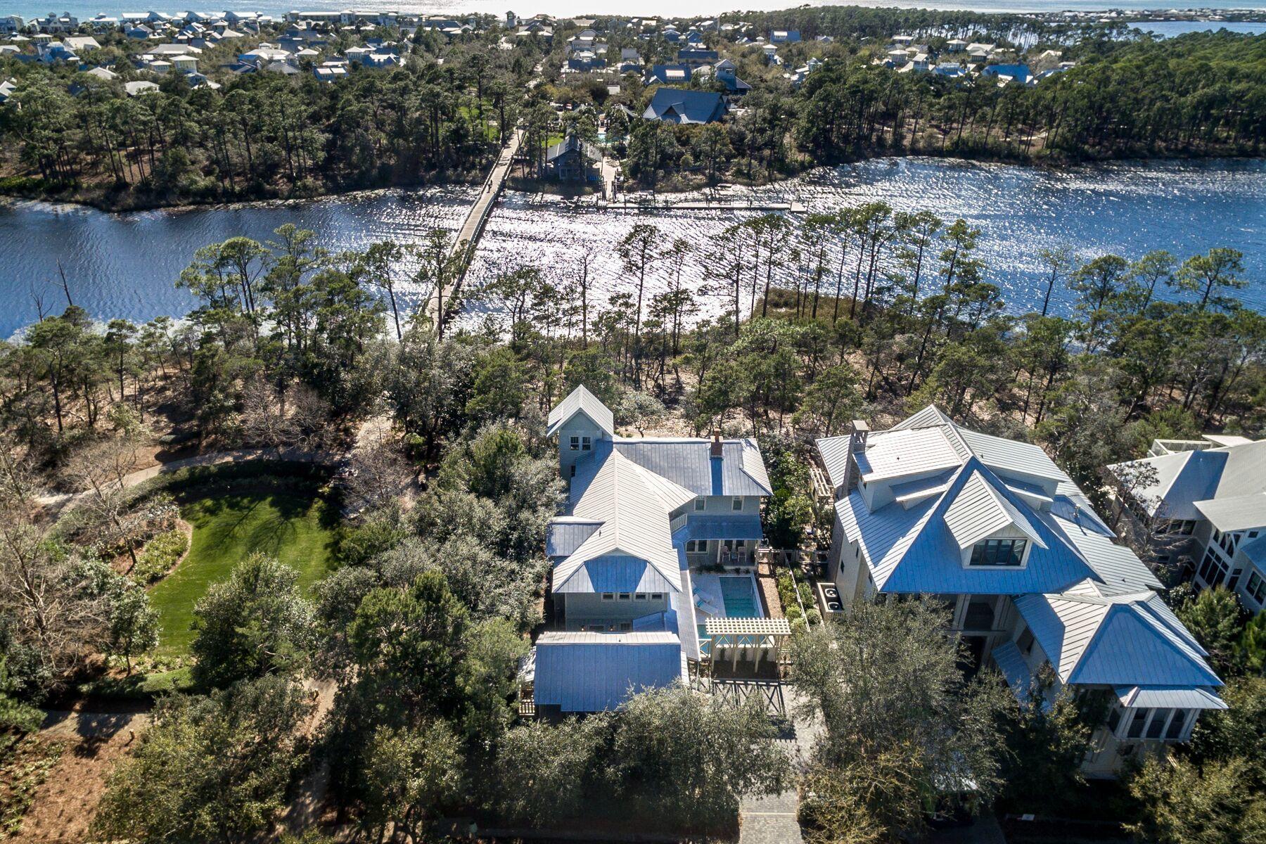 This 5 bed, 4 1/2 bath beach house its located directly on Western Lake and adjacent to Western Lake Park and the bridge to the Watercolor Boat House. Words truly cannot describe the beauty of this location, it is a must see. Enjoy your morning coffee or afternoon cocktail on one of the 1,184 square feet of porches overlooking Western Lake or your own private pool or hop on your bike or take a short walk over the bridge to the heart of Watercolor. Not only does this home offer a prime location in the community of Watercolor but is itself its own oasis. The property welcomes you with a newly added gorgeous courtyard pool designed by Chad Horton that can be viewed from the kitchen, dining, living & den areas on the first floor and also from a Juliet balcony on the second floor of the home. Lush landscape, decorative downspouts and a trellis pergola complete this serene setting. Enter the home through one of many doors that allows for an abundance of natural light to flood the home. The newly remodeled kitchen designed by Urban Grace Interiors offers a large island, viking range with custom hood, dishwasher and its own prep area/wet bar that is complete with a sink, ice maker and wine refrigerator. The kitchen opens to the dining area and then to the living area that offers a fire place making the already inviting space that much cozier. The first floor also has a den area that offers window seating that makes for a great location for all of your reading and lounging needs! For all of you dog lovers out there, this property also has a fenced in dog run off of the side porch. The first floor has a half bath in a location perfect for coming in from the pool and also a utility room with washer, dryer and 2 freezer drawers and an abundance of storage space. The entire south side of the home offers an oversized open air porch that provides for beautiful lake front views. Stroll up the spiral staircase to the second floor of the home which includes 4 bedrooms and 3 full baths.  The master bedroom has its own large balcony that again offers breathtaking views of the lake.  The master bath was newly remodeled in 2019 also by Urban Grace Interiors. It offers a soaking tub, oversized shower stall, double vanity, plantation shutters and water closet and is completed with luxurious tile. The master offers a huge walk in closet with built in shelving. A additional bedroom has an ensuite bath along with a large walk in cedar closet. Two additional bedrooms with one shared full bathroom complete the second floor. This home has a tower with amazing views of the lake. This space could be utilized in many different ways from a craft room, office, book nook or it would perfect for the star gazer! The home has a one car garage with a fully appointed carriage house above it to include a full bath, bedroom and kitchen area complete with sink, dishwasher, mini refrigerator and microwave. This is a one owner home, that has never been rented. The WaterColor community includes residential homes and a beach-side resort on the beautiful Gulf of Mexico and the breathtaking coastal dune lake, Western Lake. Quaint streets and pathways connect homes to the community parks, shops, the lake and the beach making biking, running and walking that much more enjoyable! The Watercolor community offers several resort style pools to include water slides and a lazy river, tennis courts, basketball courts, playgrounds, fitness center and a boathouse stocked with kayaks, canoes, paddle boards and fishing equipment. Call for a showing today!