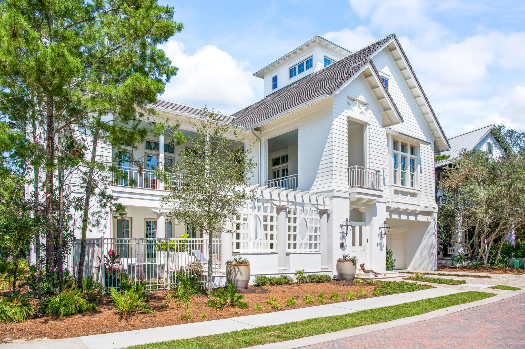 Introducing 'The Heritage' –The VIE Legacy Show Home  exemplifying the best of luxury living on 30A with gulf views in the rental restricted gated beachfront neighborhood of Heritage Dunes.  Step into exquisitely furnished 76 N. Heritage Dunes Lane and experience this timeless Southern coastal home designed by Gerald Burwell of Burwell & Associates and expertly constructed by Grand Bay Construction. The indoor and outdoor spaces are intentionally designed for timeless comfort, selecting the finest materials and appointments for their enjoyment, appeal and durability.  Interior Designer Duce May creates an unrivaled sense of beachside life by incorporating Ralph Lauren Modern Collection furnishings, accessories and art you would expect from a VIE Legacy Show Home. Signature features of the home include light filled rooms with high ceilings, hardwood floors, an elevator, EF San Juan custom windows and doors, special lighting, security, sound system, and curated designer furnishings.  Each level provides ample space for family and guests to gather, making the home an ideal place for entertaining.
Entering the foyer, the ground level features two bedrooms with en suite baths for guests, a powder room, and a large, welcoming entertainment room with direct access to the outdoor poolside veranda.
The main second floor living area includes a spacious kitchen, dining and living room with soaring ash beamed ceiling, anchored by a striking coquina fireplace with custom mantel.  French doors to the surrounding veranda extend the generous living space outside. The gourmet kitchen with adjoining butler's pantry features side-by-side Sub Zero refrigeration, 48-inch dual fuel 6-burner with infrared griddle Wolf range, and Cove dishwasher. The Master Bedroom Suite features a wine and coffee bar, dual customized closets, a spa like bath, and also opens to the wrap around veranda featuring Bevolo gas lanterns.   On the third level, two additional bedrooms share a seating room, while the fourth floor Tower/Sky Bar Room features window-filled Euro-Walls providing extraordinary neighborhood and gulf views, which can be opened to enjoy a perfect beach breeze or closed to enjoy the comfort and convenience of the climate-controlled space.  
Outside, landscape architect Patrick Hodges brings the pool scape, outdoor gardens and verandas to life, seamlessly incorporating the grounds with the surrounding natural environment.  The southern exposure pool crowned with a pergola and colonnade is fed by water emanating from two separate walls creating a soothing resonance of falling water. 
We invite you to discover 76 N. Heritage Dunes by scheduling an appointment to personally experience this wonderfully designed and constructed residence.