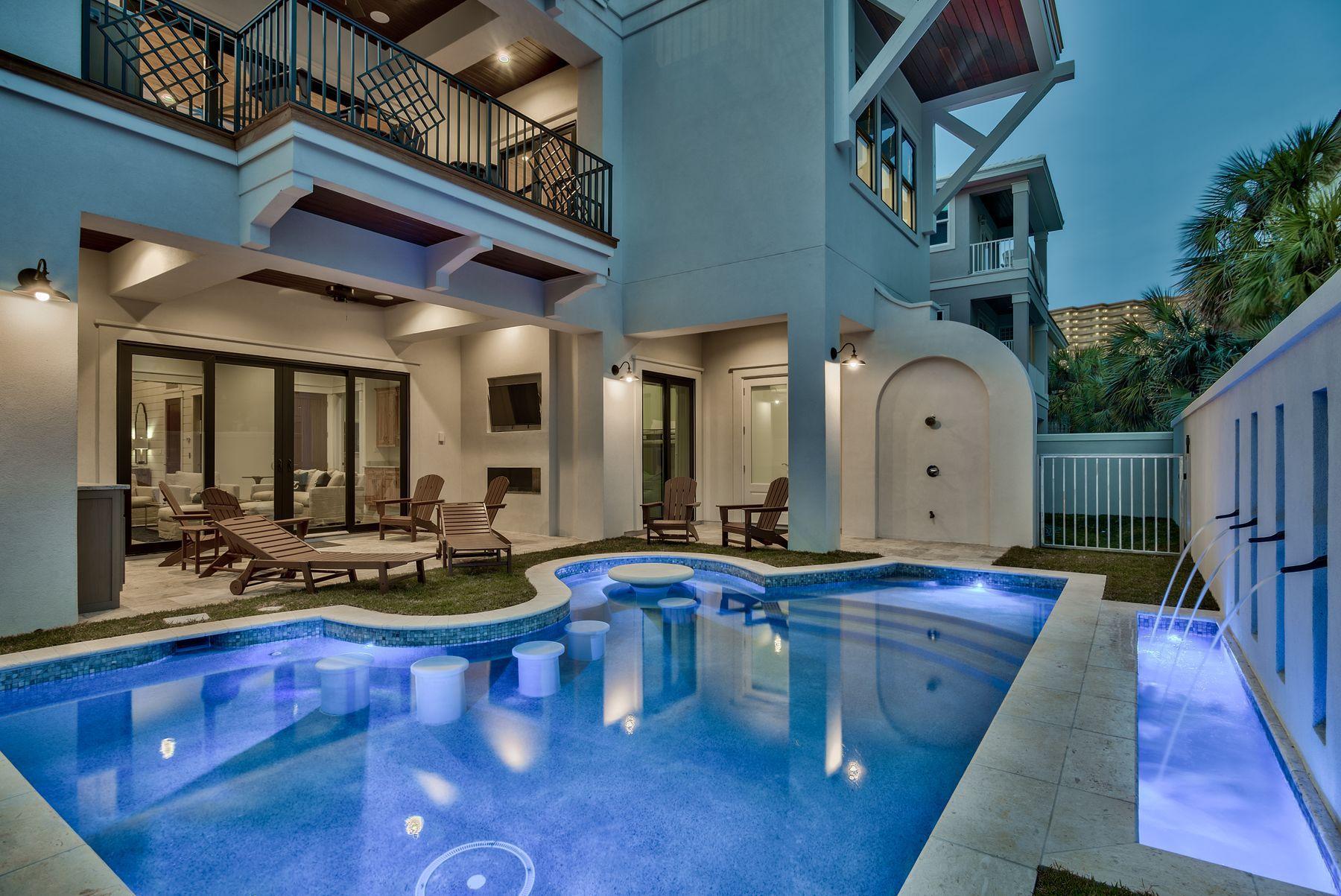 Discover this newly constructed coastal architectural marvel perfectly situated to capture gulf views & masterfully configured providing unparalleled amenities including a Watermark-built private resort style pool area complete with a covered outdoor summer kitchen and adjoining spa. This is the ultimate beach house, an excellent income producer with outstanding opportunity to yield short term rental income. This home was designed to maximize functionality and finely appointed with chic coastal finishes while affording optimal comfort & living space. Notable features include multiple indoor and outdoor living areas, private commercial grade elevator, dual master suites with gulf views, built-in pinterest worthy bunkbeds, indoor and outdoor surround sound system as well as security cameras for optimal privacy. The first floor layout boasts a soaring double height ceiling entry way as well as an oversized bunk room, full size laundry area, large bedroom with ensuite bath and an oversized living room complete with a built in wet bar flowing seamlessly out to the rear pool deck and covered outdoor living area. The second floor is the focal point of indoor living space offering a wide open layout complete with living room featuring floor to ceiling windows to soak in natural light & gulf views, pecky cypress ceilings, spacious living areas open to the kitchen & dining room for optimal flow. The ample sized kitchen features floor-to-ceiling custom contemporary cabinetry, stainless appliances and professional series gas range, ample storage and is anchored by a massive center island crowned with gorgeous quartz countertops. The second floor also features two full bedrooms with ensuite bathrooms, convenient half bath as well as access to the second story outdoor living area overlooking the lagoon style pool and enjoying beautiful gulf views. The third floor features three full bedrooms including dual master suites with spacious porches, laundry area, bunk room as well as multiple private balconies maximizing the incredible gulf and southern oriented views that surround this prestigious home. Dunes of Destin owners enjoy deeded, gated beach access steps from the home as well as a community pool and is centrally located near world class golfing, dining, shopping & entertainment.