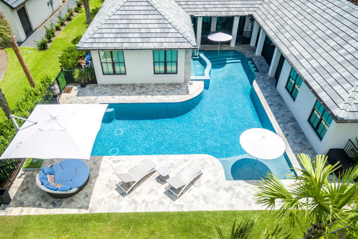 What an amazing home and pool area !!! Newly built, this exquisite custom built by Huff Homes overlooking The Raven Golf Course is a rare find. Thoughtfully designed and meticulously maintained, 3956 is a desirable single level home complete with a separate guest house and state of the art outdoor living space and pool. Exterior features include over sized ozone heated and cooled pool with swim up bar for 4 and a10 person hot tub with waterfall and wall mount fire torches. The summer kitchen and outdoor living space were built for Florida living with a SubZero refrigerator, 4 ft gas grill, outdoor shower, pool bath, fire pit and high top table bar. The interior is spaciously designed with 5 bedroom, 4 full bath, with 3 additional half bath. The kitchen features a Wolf gas stove top w/ additional flat top, a 6 ft. Electrolux side by side refrigerator, 2 dishwashers, 10 x 4 Island. Built in Wine Cellar, panic/safe room, with secutiry system with CCTV. Large master suite offers 2 large separate walk-in his and her closets.

The master en suite features a double vanity with Marble countertop, Jacuzzi Tub framed in Marble, Marble shower with multiple shower heads and Marble flooring. Tile flooring throughout the home. The guest house is outfitted for comfort with a Mini kitchen, refrigerator, bar, and an oversized closet. Study has a half bath as well as 2 separate closets for storage or can be used as a 5th bedroom. Fenced in backyard with additional pool fence and 3 full car garge. 32 KW Gas Genearc Generator,