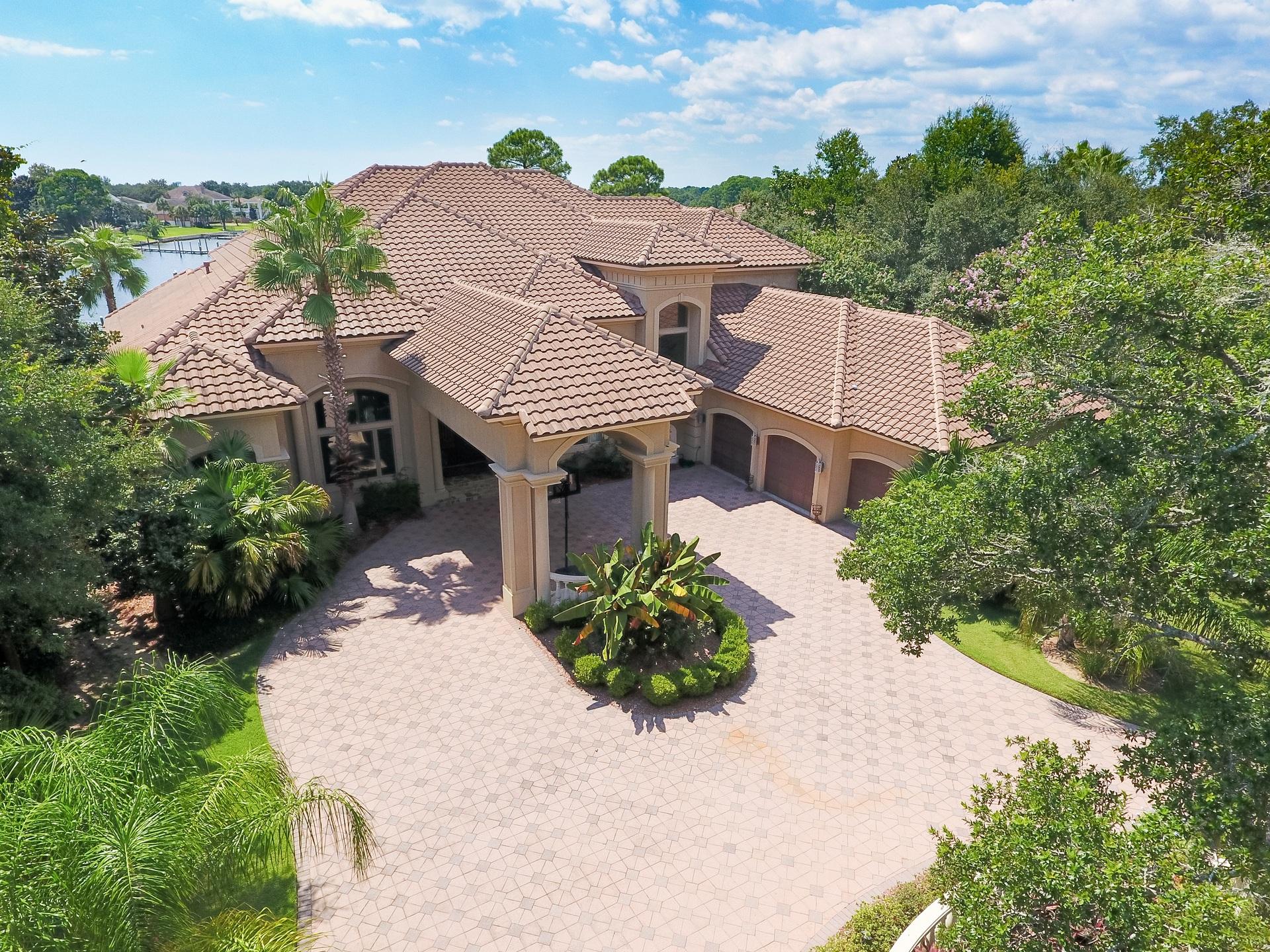 Rare opportunity to own a luxury residence offering waterfront living and boating at it's best! Situated on wide, deep water within the gates of desirable Kelly Plantation, on a lot graced with mature live oaks and magnolias, with 145 feet of bayou frontage. Meticulously designed for gracious entertaining and family living, with no details overlooked and a well designed floor plan that utilizes every inch of space. Fabulous curb appeal, with a brick paver circular drive and porte-cochere and gorgeous hand forged double wrought iron doors opening into a grand foyer, living room with soaring 23 foot coffered ceilings, the adjoining formal dining room and a handsome study/library with custom mahogany built-ins. The luxurious master wing is to the left...and is nothing short of opulent, with a spacious waterfront bedroom, two large walk-in closets, sumptuous bath with large double vanity, private water closet, huge walk-in shower, soaking tub.   Just off the living area is the spacious, open concept heart of the home....with a large casual dining area, a kitchen that is just fantastic with tons of custom cabinetry, gleaming granite counters, a huge breakfast bar, large walk-in pantry, upgraded appliances, and a leisure room with sliding glass pocket doors opening on a 45 degree angle onto the outdoor living area.  Two additional ensuite guest rooms are on the first level as well as a generously sized laundry center and a storage room.  On the second level is a large loft area, perfect as a den or game room, two ensuite guest bedrooms, and a large 12.5'x 29' heated and cooled storage room.   Finely appointed with custom features throughout including spectacular mantle and fireplace surround, deep crown molding, travertine floors, coffered ceilings, recessed and art lighting, designer lighting, faux finishes, custom cabinetry and built-ins and so much more. Everyone will love the outdoor living area, with summer kitchen, pool with stacked stone water feature, private dock with boat slips and watercraft lifts.  Dockage will accommodate a large vessel. The open bay is only three lots away and it's just a short boat ride to Crab Island, Destin Harbor and the Gulf.   For added peace of mind, a 65 KW generator powers the entire home in case of power outage.  If it's water front living you're searching for...you've found it!