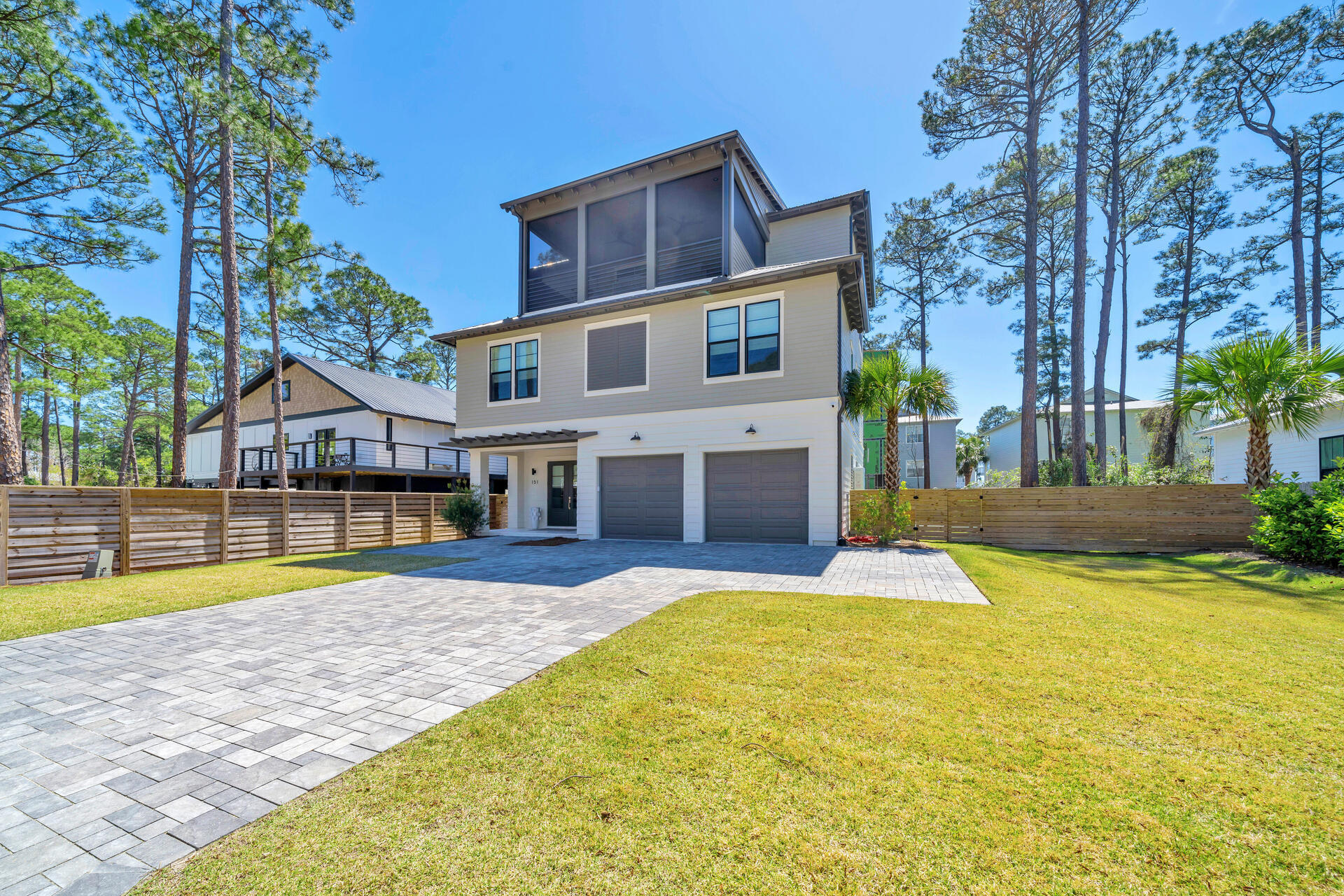 Built in 2022, this beautifully designed and elegantly furnished home in the coveted area of Oyster Lake on 30A. The modern floor plan includes multiple indoor and outdoor living spaces, an elevator which services all three levels, private in-ground swimming pool, outdoor kitchen, and much more.  The furnishings and decor were curated by Beau Interiors in Grayton Beach.  The moment you pull up to the property you will immediately notice the curb appeal, and features such as the oversized paver driveway, two car garage, screened in and covered 3rd floor patio, and the horizontal privacy fence surrounding the back yard of the property. As you head inside you are greeted by the foyer which leads you to the 2-car garage on the right, the stairs leading to the additional floors to the left, or straight ahead to the 1st floor sitting area, wet bar, bunk room with 6 built in bunks and ensuite bathroom, half bath, and laundry room with 2 stackable washers and dryers.

You can also head out to the back covered patio with outdoor summer kitchen, sitting area, and swimming pool with lounge pad.
Take either the stairs or the elevator to the 2nd floor where you will find the sleeping space. Here you will find the master bedroom and 3 additional bedrooms all with private bathrooms. The master suite has access to the 2nd floor covered balcony, large walk-in closet, double vanity, floor to ceiling tiled shower and soaking tub.
On the 3rd floor is the main living space and two more covered balconies. Here you have the sitting area, dining table for 10, and kitchen with quartz counter tops and kitchen island/breakfast bar. All stainless-steel appliances adorn the kitchen, and the oversized, walk-in pantry is something of dreams. There's even another storage closet inside the pantry where the 3rd floor HVAC can be found. Outside on the back facing patio you have yet another sitting area and ceiling fans which can also be found on the front facing balcony which additionally is screened.
Being adjacent to 30A means beach access, dining and entertainment are all just a walk or golf cart ride away. Don't wait, schedule your private showing TODAY!
