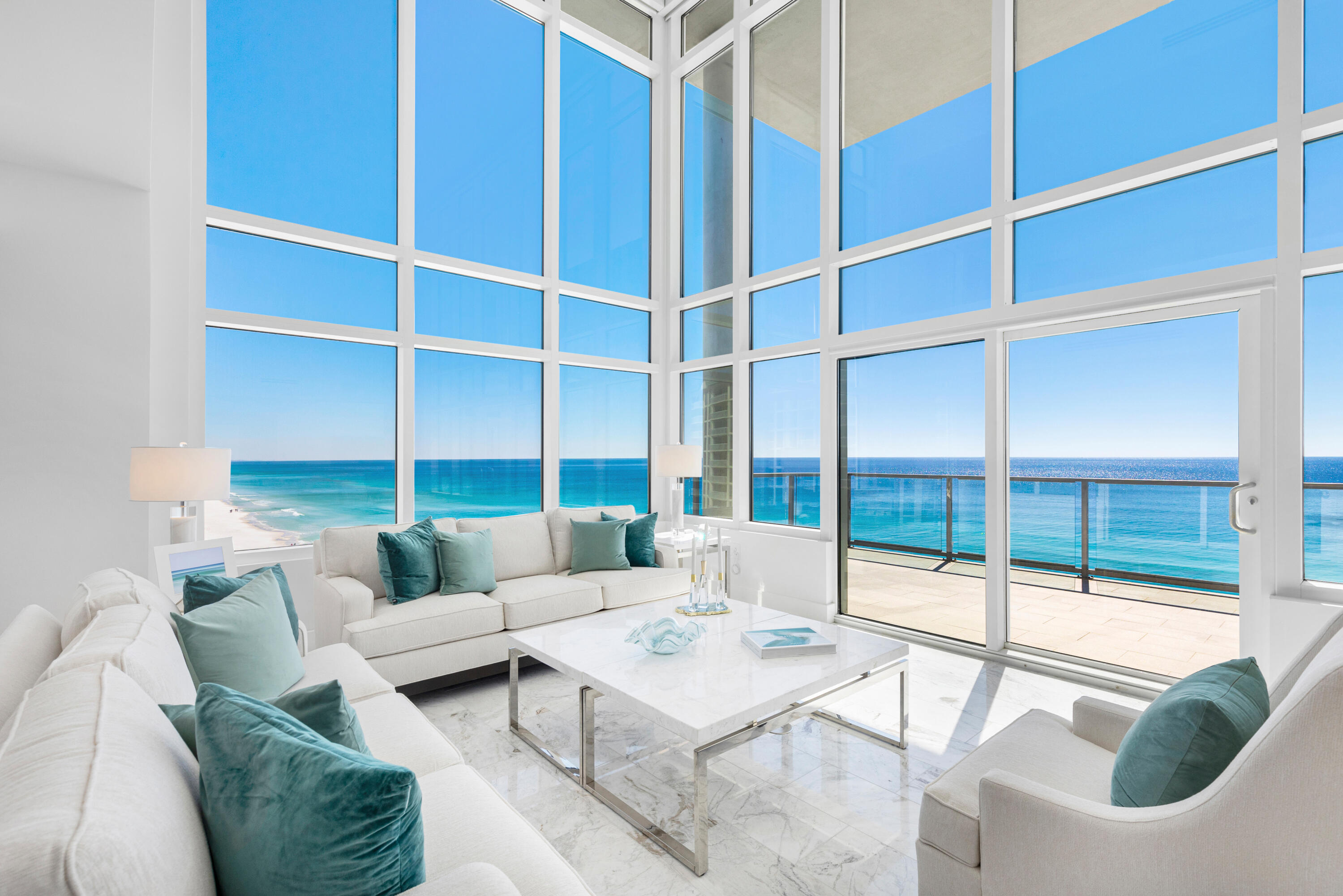 Experience modern coastal luxury in this one-of-a-kind 4-bedroom + bonus room, 4.5-bath multi-level penthouse, spanning just under 5,000 sq ft of unparalleled opulence, where timeless elegance meets cutting-edge technology. Step inside and be captivated by soaring 18 ft ceilings and expansive walls of glass showcasing breathtaking Gulf views from the 10th floor. Every inch of this extraordinary residence has been meticulously redesigned, from the custom-crafted kitchen with enhanced butler's pantry to the spa-like primary suite. Polished marble flooring extends throughout the home and ascends the floor-to-ceiling marble walls in the primary and half baths. The open concept living and dining areas flow seamlessly. Enjoy an extensive 344 sq ft balcony where you can relax to the tranquil sound of the waves. The chef's kitchen is a culinary masterpiece featuring upscale Thermador appliances, stunning white quartz countertops & backsplash, and custom cabinetry with natural wood interiors & Blum Movento push-to-open hardware. An enhanced butler's pantry provides additional prep space equipped with a wine & beverage fridge, perfect for entertaining. The sleek, modern aesthetic is further enhanced by custom sliding pocket doors with glass panels & Emtek hardware featured in the primary bath, laundry room, and pantry.

Thoughtfully designed for both comfort and maximal Gulf views, this home offers a spacious first-floor bedroom, while the second level--also accessible via a private in-home elevator--is dedicated to luxury living and encompasses the primary suite, an additional bedroom with en suite bath, media room, and versatile loft space with a full bathroom and closet--ideal for a home office or bedroom. The open den with glass surround currently encompasses breathtaking, panoramic views of the Gulf but could also easily be enclosed and converted back into a true fifth bedroom like the original plan, if desired.

Retreat to the primary suite, a private sanctuary to unwind, offering panoramic coastline views from the private balcony, a spa-inspired bathroom with garden tub which also enjoys Gulf views thanks to the wall cutout, and a sizeable custom walk-in closet.

Every aspect of this penthouse has been curated for convenience, comfort, and control. State-of-the-art Lutron Homeworks system makes controlling the lights, shades, and fans throughout the home effortless. The home is equipped with 149 state of the art lights made by Porsche that mimics natural light, 28 high-end Paladiom Lutron automated shades, with Lutron QED motors installed in the living room for the impressive 18 ft drop. Entertainment is next-level with an all-house Russound audio system spanning 12 zones, including the balcony, with premium in-wall speakers in every room and custom-mounted iPads for control. A 98" QLED TV with a Yamaha surround sound system adorns the media room, while 6 custom-installed framed TVs provide an elevated entertainment experience throughout the home.

Designed with security and efficiency top of mind, the penthouse features a Leviton security system with automated video at both entrances, motion-activated lighting in select areas, and an HOA-approved balcony camera with 25x optical zoom, night vision, and remote access. The home is outfitted with a high-performance Unifi internet system with 8 custom-installed access points, 72 ports, and 650W POE capacity fully integrated with the building's internet service at no additional monthly cost. A dedicated lockable communications room neatly houses all electronic components for efficient connectivity and troubleshooting. Additional smart-home features include pre-installed water leak sensors with an automated main water shut-off system and remote-controlled water heater functionality for energy savings when you're away.

Beyond the residence, resort-style amenities elevate the luxurious lifestyle, including a rooftop oasis complete with a pool, hot tub, and fitness center. A gated parking garage provides 2 dedicated parking spaces ensuring convenience and security. This exceptional penthouse is more than just a home--it's an immersive living experience where coastal luxury, innovation, and ultramodern design converge in perfect harmony. Not only do you have panoramic views of the Gulf, you have incredible views of Henderson Beach State Park to the east from this exceptional, 2-story corner unit. This is a rare opportunity to own a true masterpiece in one of the most coveted locations.