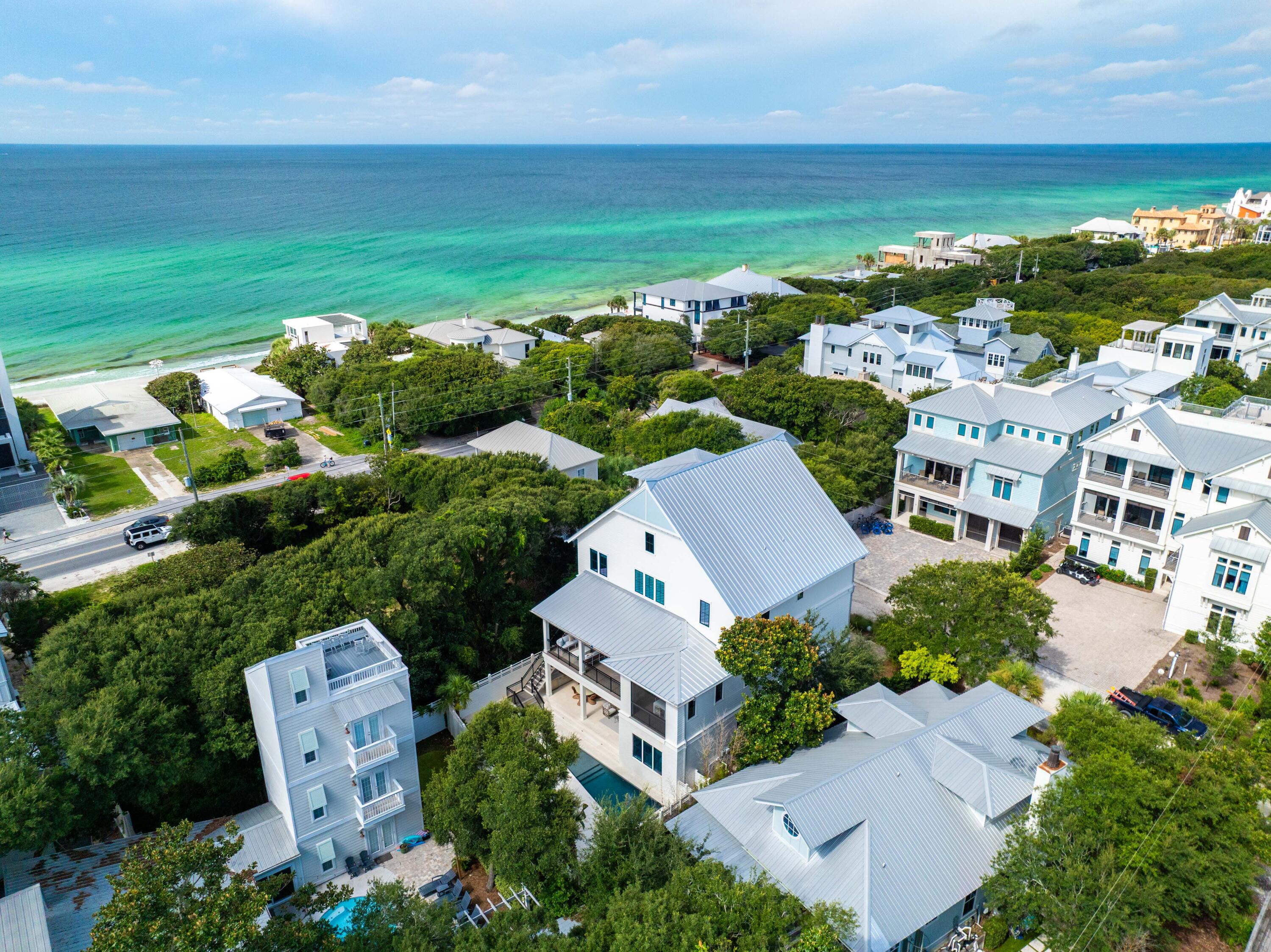 Perfectly positioned in the sought-after Old Seagrove community, 32 Camellia is a stunning coastal estate offering 6,645 square feet of beautifully designed living space. With panoramic Gulf views from multiple levels, this eight-bedroom, nine-bathroom home was thoughtfully crafted for multi-generational living, seamless entertaining, and luxurious comfort.

The first floor welcomes you with a spacious entertainment lounge, two guest bedrooms, and direct access to a private backyard oasis—complete with a sparkling pool and a fully equipped summer kitchen ideal for hosting gatherings year-round.

Upstairs, the second level features an expansive open-concept kitchen, dining, and living area that flows effortlessly onto a covered porch overlooking the pool. A serene primary suite completes this level, offering privacy and elegance. The third floor boasts an additional living space, three ensuite bedrooms, and two oversized bunk roomsperfect for extended family or guests.

Crowning the home is a top-level rooftop deck and covered viewing porch that captures breathtaking, unobstructed Gulf viewsan idyllic setting for sunsets, morning coffee, or evening cocktails.

Designed for effortless indoor-outdoor living, multiple porches and gathering spaces create the ultimate coastal retreat. High-end finishes, designer lighting, and carefully curated interiors bring a refined, yet relaxed sophistication to every room.

Located just steps from the sugar-white sands via the nearby Gardenia Street beach access, and within easy walking distance to the vibrant shops and dining of Seaside and WaterColor, this home offers both tranquility and convenience.

Whether you're looking for a luxury second home, a full-time residence, or a high-performing vacation rental, 32 Camellia delivers exceptional potential and an unparalleled 30A lifestyle.

Inquire today and make your dream of coastal living a reality.