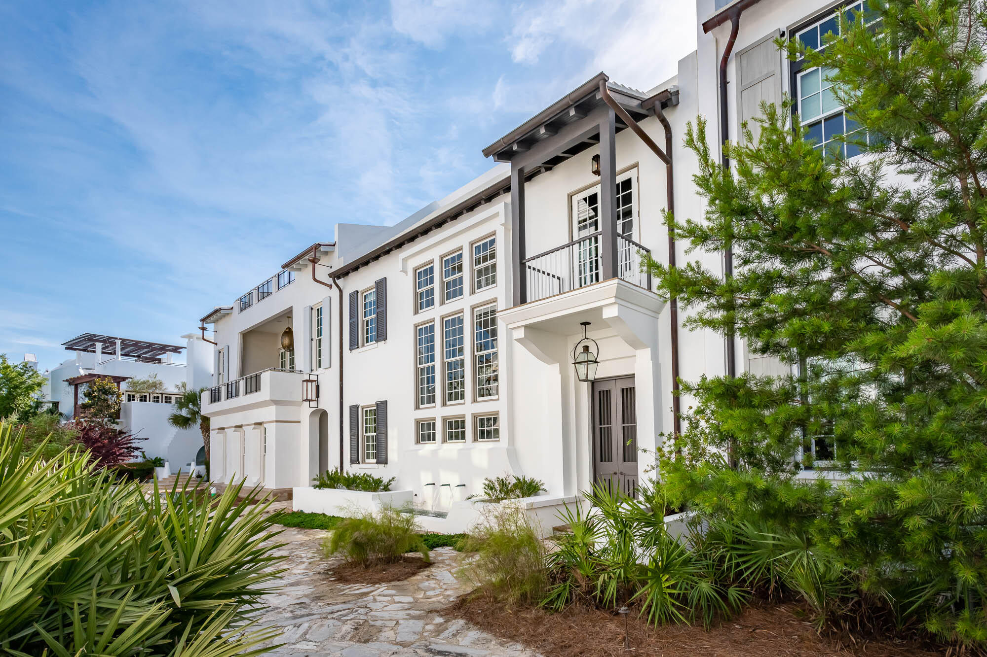 TMc Architecture created the quintessential Antiguan influenced home that Alys Beach personifies, pairing the indoor living with the outdoor.  Connectivity begins with the 1st level kitchen, dining, & living rooms that open to the private courtyard hosting an enclosed loggia featuring beverage center, grill, & fireplace.  Operable glass doors function to enclose for those chilly evenings.
The primary elevation fronts the award-winning Sea Garden Walk pedestrian path creating a special environment for guests to enter the home and easy pedestrian travel to the private owners Beach Club, Caliza Pool, and Zuma Wellness Center.  North to Lake Marilyn & the nature preserve or south to the beach by way of Sea Garden Walk.  
Entering the home draws attention to the ebonized machined steel, floating staircase softened by reclaimed Oak stair treads derived from the same origin as the Oak ceiling beams and flooring.  11' ceiling height paired with full height windows nicely transfers the east to west sunlight throughout the dining, kitchen, & living areas reflecting upon the Venetian Plaster for peaceful ambiance.
The kitchen is appointed with professional appliances centered with a large marble island looking upon the dining & living area.  For work interruption, an office located privately off the kitchen is available for such.  Outdoor entertaining is achievable having the outdoor covered loggia steps from the kitchen leading to the courtyard open to the sky.  Guests will be enamored by the uses of the private outdoor gathering spaces.
55 Hog Penny Alley boasts 4 bedrooms plus a double bunk room to accommodate family & friends. The primary bedroom suite is exclusive capturing privacy that opens to a personal roof terrace for those moon lit nights. In addition to, the primary has a private stair hall with direction to the home's glass, enclosed studio providing refuge as a media room, secondary living room or for a Zen yoga studio.  
The 3 guest suites & double bunk rooms are opposite to the primary bedroom for timely separation and privacy. Tastefully appointed bathrooms to suit.  
Additionally, this property provides a two car garages plus walk-in owners closet with 2nd refrigerator and additional storage closets for beach accompaniments and the like.  Furnishings convey with the sale.  This home is a must see and ready for immediate occupancy.