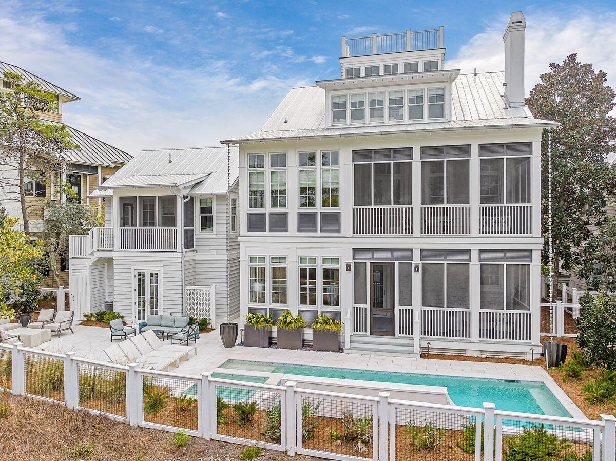 Stunning views of Western Lake are just one of the benefits of this spectacular six-bedroom, six-bath home by architect TS Adams. Located on a generous lot in WaterColor Phase I, this Southern-style home has a beautiful private pool and spa, carriage house and a two-car garage. Generous screened porches and a stunning rooftop terrace with expansive Western Lake views and peek-a-boo gulf views make this a desirable residence for those who crave outdoor living. Renovated in 2018, this luxurious residence boasts high-end finishes including Venetian plaster, cypress accent ceilings, solid poplar doors and over $100,000 in custom window treatments. The solid mahogany front door is flanked by flickering gas lanterns, setting the tone for what's to come. The grand entrance leads into a hallway leading to three bedrooms including a lavish master suite with sliding barn doors to a private sitting area. The main living/ dining rooms are located on the second floor, taking advantage of the extra-tall ceilings, multiple windows and serene views. This floor also boasts a bedroom and full bath complete with custom built in closet cabinets. Cypress ceilings and white oak flooring bond the home with its natural surroundings while state-of-the-art features extend to lighting, plumbing and even the air-conditioned garage storage. The gourmet kitchen is the chef's domain with an oversized island, Wolf appliances and a butler's pantry. Head to the third floor where a bunk room with bathroom welcome you in along with a second living area/media room and an additional room currently used as an office. Custom stairs lead up to the rooftop lookout and breezy catwalk, delivering breathtaking views of Western Lake. The carriage house above the two-car garage provides luxurious accommodation for semi-independent guests. It has a beautiful bedroom, bathroom, living room and neat kitchenette. It still leaves ample space for entertaining on the paved terrace around the pool. The serene coastal dune lake provides a recreational paradise for fishing, paddleboarding and kayaking, surrounded by nature. Conveniently close to the beach, beach club and WaterColor restaurants and shops, this home is an astounding residence with a proven rental history.