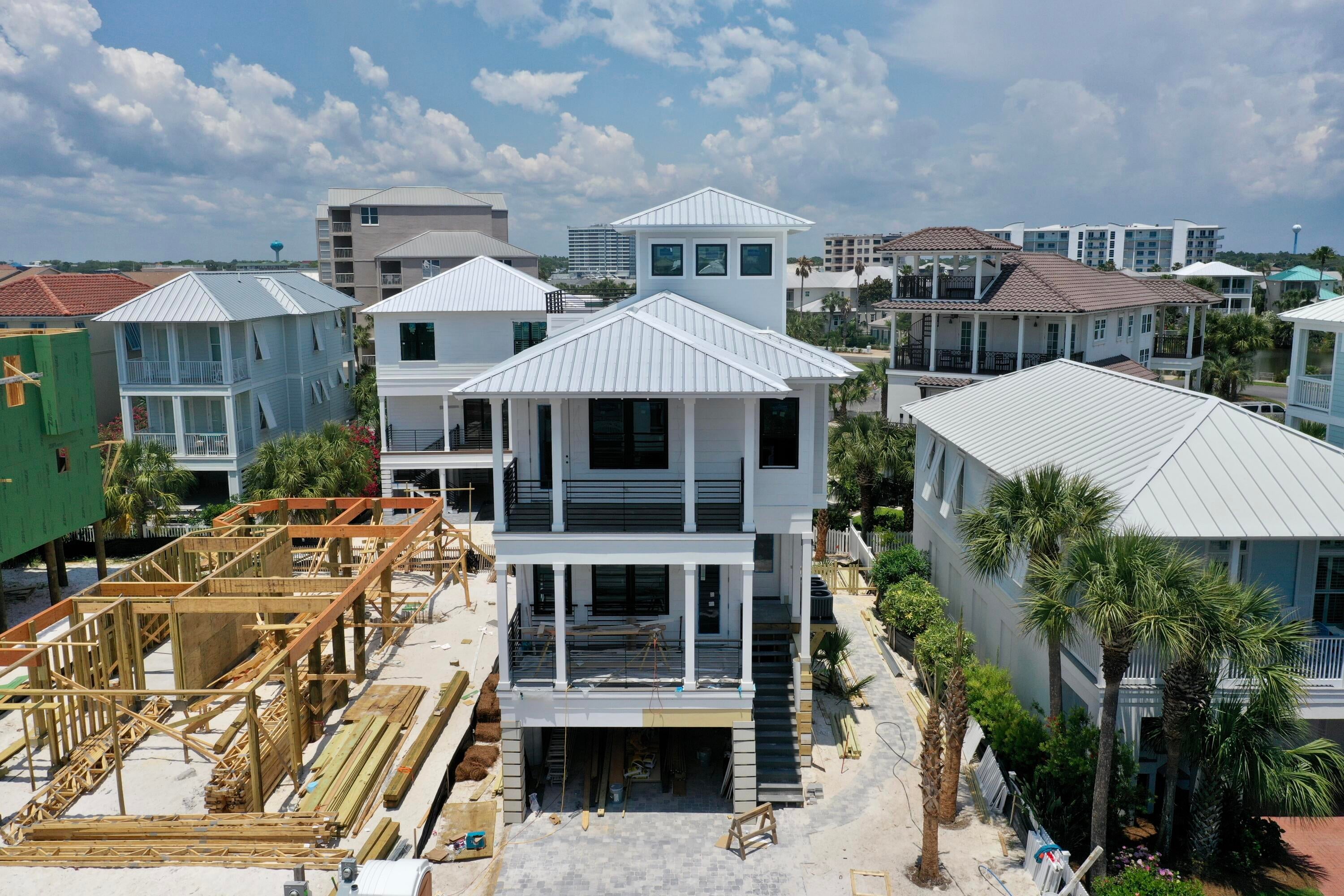 Rare opportunity to own a beautiful, brand-new construction in Destin Pointe! This home has it all, boasting upgrades galore on all four levels with tons of natural light and shiplap wall accents throughout. The first floor offers a partially covered, heated saltwater pool with a brick paved deck. The main level boasts open concept living with kitchen, dining and living room flowing into the spacious front deck. The chef's kitchen is equipped with a ZLINE gas range, Kitchen Aid appliances, Brizo luxe fixtures and faucets, quartz countertops, floating shelves, and soft close cabinets. Just beyond, you'll find a lovely private bedroom, including an ensuite bath and large private deck. On the third floor you will enjoy this home's 3 additional bedrooms along with a 5-bed bunk room. Two of these guest spaces boast room for king-sized beds, with one offering a secluded and spacious private deck. The luxurious owner's suite can be found here as well, where you will enjoy stunning gulf views from the peaceful, private deck. The fourth floor brings you to the lookout tower with incredible views in all directions. The conditioned tower room is perfect for entertaining or relaxing, while the gulf/pass facing deck is perfect for soaking in the magnificent views and relaxing with the soothing gulf breeze. Construction features include but are not limited to: a robust HVAC system, durable composite decking, Navien tankless water heater, high quality LVP flooring, Hardie board siding, custom railings and handrails, spray foam insulation throughout, and standing seam metal roof. Expertly designed with livability and comfort in mind, this beautiful beach home will exceed your expectations as a primary residence, vacation getaway, or investment property with revenue projection of $210K! Destin Pointe is an exclusive beachside community in the heart of Destin offering over 3,000' of private beach access, two community pool areas, tennis courts, two lakes, shuffleboard, seasonal beach shuttle, and 24-hour security. Within minutes to shopping, dining, entertainment, and world class beaches, this home is sure to impress in all aspects. Call today to schedule your showing!
