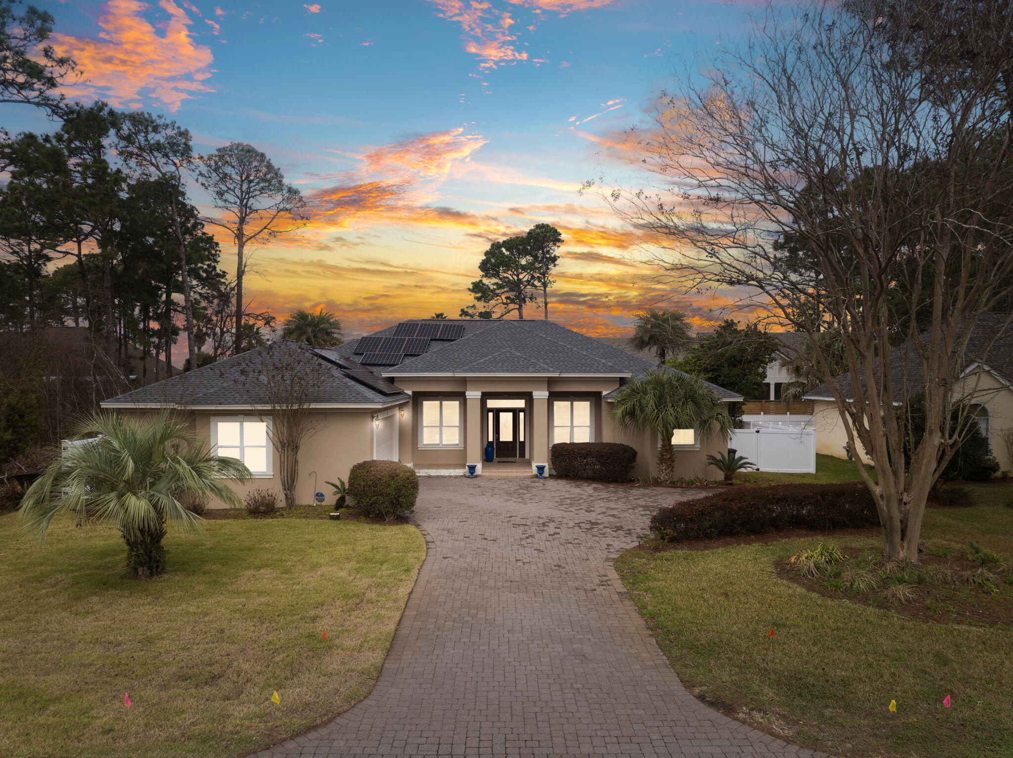 Welcome to your new home! This stunning 4-bedroom, 2-bathroom custom-built home offers the perfect blend of comfort, efficiency, and style. Nestled on a quarter-acre lot, just a block away from the bay, in a non-flood 'X' zone, this property is designed for effortless living and entertaining. From the moment you arrive, the newly paved driveway, and expansive garage provides ample parking for both you and your guests. Step inside this beautifully designed home and experience the perfect balance of space and elegance. The raised 13-foot vaulted ceilings create an open and airy atmosphere, allowing natural light to fill the home. The expansive living area offers plenty of room for relaxation and entertaining, seamlessly flowing into the kitchen and dining spaces.  The gourmet kitchen features modern appliances, ample counter space, and custom cabinetry, making it both functional and stylish. The primary suite is a true retreat, with large windows, private access to the porch, and a spa-like ensuite bathroom. The additional three bedrooms provide comfort and flexibility, perfect for guests, family, or even a home office. Throughout the home, you'll find thoughtful design elements, from elegant flooring to custom built-ins, and high-end finishes, ensuring both beauty and practicality. Whether you're hosting gatherings or enjoying a quiet night in, this home's open-layout and impressive ceiling heights create a warm and inviting space you'll love coming home to. The focal point of the home is the backyard oasis, with a heated/cooled pool allowing for year-round enjoyment. The spacious screened-in back porch overlooks the beautifully newly landscaped, fully fenced yard, complete with low-maintenance newly installed astroturf for a pristine look without the hassle of having to ever water the grass. One of the home's notable features is its fully paid-off solar panels, which power the housemeaning, no electric bill! This home is truly a rare find. Newly installed LVP flooring, and carpet. The home was also recently painted on the inside and outside. In a non-HOA area. Located just 5-minutes to the nearest beach access, in the middle of Miramar Beach, close-by restaurants, grocery stores, shopping and entertainment. Don't miss outschedule your private tour today!