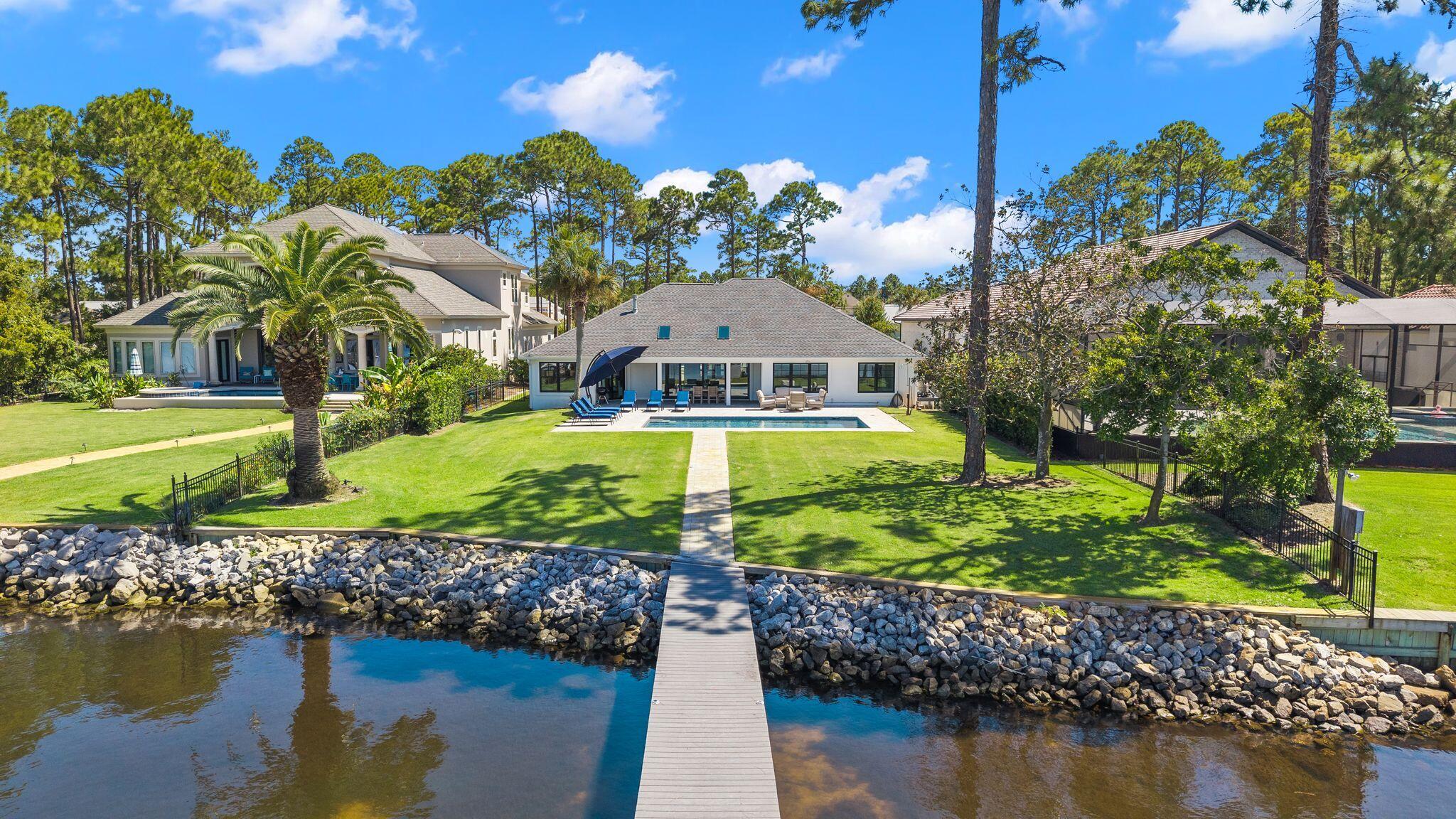 Luxury Bayfront Living in the Heart of Miramar Beach! Completely renovated and perfectly positioned on the shores of Choctawhatchee Bay, and just a 4 min golf cart ride to the Beach, this exceptional estate offers approximately 3,000 sq. ft. of beautifully updated living space, including a 4-bedroom, 4-bath main residence and a detached 1-bedroom, 1-bath guest house--ideal for guests, extended family, or additional income. Designed for effortless single-level living, the main home features a desirable split-bedroom floor plan, luxury vinyl plank flooring throughout, and an open-concept layout that captures stunning bay views. The chef's kitchen has been completely reimagined with high-end finishes, while all bathrooms have been tastefully renovated, including the addition of 2 bathrooms. Step outside to your private waterfront oasis featuring a new heated saltwater gunite pool surrounded by elegant paver decking, your own private dock perfect for paddleboarding, kayaking, fishing, boating, or simply unwinding while taking in breathtaking sunset views. Lush new landscaping, and breathtaking views of Choctawhatchee Bay. Additional upgrades include new interior and exterior paint, all new windows and doors, a new HVAC system, and a new seawall. Located just a few homes down from Legion Park on the Bay, you'll have easy access to a public boat launch, pickleball and basketball courts, a playground, picnic areas, and scenic waterfront green space--all just a short stroll from your front door. There is a gas line outback allowing for outdoor kitchen/firepit to be added. This is more than just a home--it's the waterfront lifestyle people dream of.