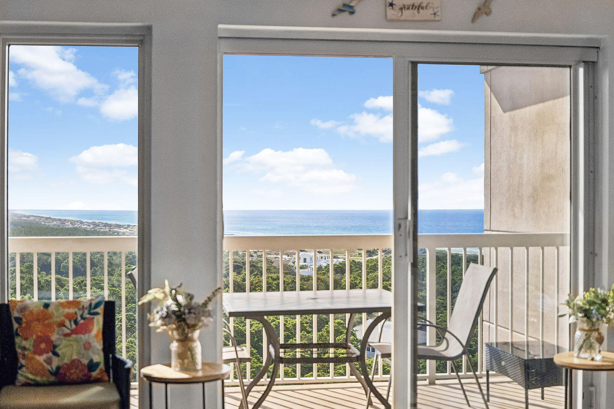 Perched on the coveted top floor of Summit at Tops'l Beach and Racquet Resort, this two-bedroom, two-bath penthouse condominium offers a perspective few properties along the Emerald Coast can match. Framed by sweeping views across Coffeen Nature Preserve, Fuller Lake, Topsail Hill Preserve State Park, and the Gulf, the residence captures a rare combination of emerald waters and protected natural landscapes that will remain preserved for generations to come.

Inside, a bright coastal palette and thoughtfully curated interiors create an inviting retreat equally suited for a primary residence, second home, or vacation rental investment. Offered fully furnished and turnkey, the property presents an exceptional opportunity to begin enjoying the coastal lifestyle immediately. The open-concept floor plan is designed to maximize both the natural light and the spectacular setting, while the spacious balcony serves as an extension of the living space, offering a front-row seat to some of the most unique views in Walton County.

This condominium features 10-foot ceilings, transom windows that fill the home with additional natural light, an oversized balcony, and one of the few deeded covered parking spaces available. Additional highlights include an in-unit washer and dryer, a well-appointed kitchen with stainless steel appliances, beautiful bathrooms with custom tiled showers, and a calming coastal aesthetic that complements the natural beauty just beyond the windows. Spanning 52 gated acres with more than 600 feet of private beach frontage, Tops'l Beach and Racquet Resort is widely recognized for its exceptional collection of amenities. Owners and guests enjoy access to multiple pools, a fitness center, hot tub, tennis and racquet sports facilities, on-site dining, and convenient beach access, all while being surrounded by some of the area's most treasured natural landscapes.

Ideally located between Grand Boulevard, Sandestin, Silver Sands Premium Outlets, and the scenic beauty of Topsail Hill Preserve State Park, this exceptional property offers the perfect balance of recreation, convenience, and the peaceful setting that makes this stretch of the Emerald Coast so special.