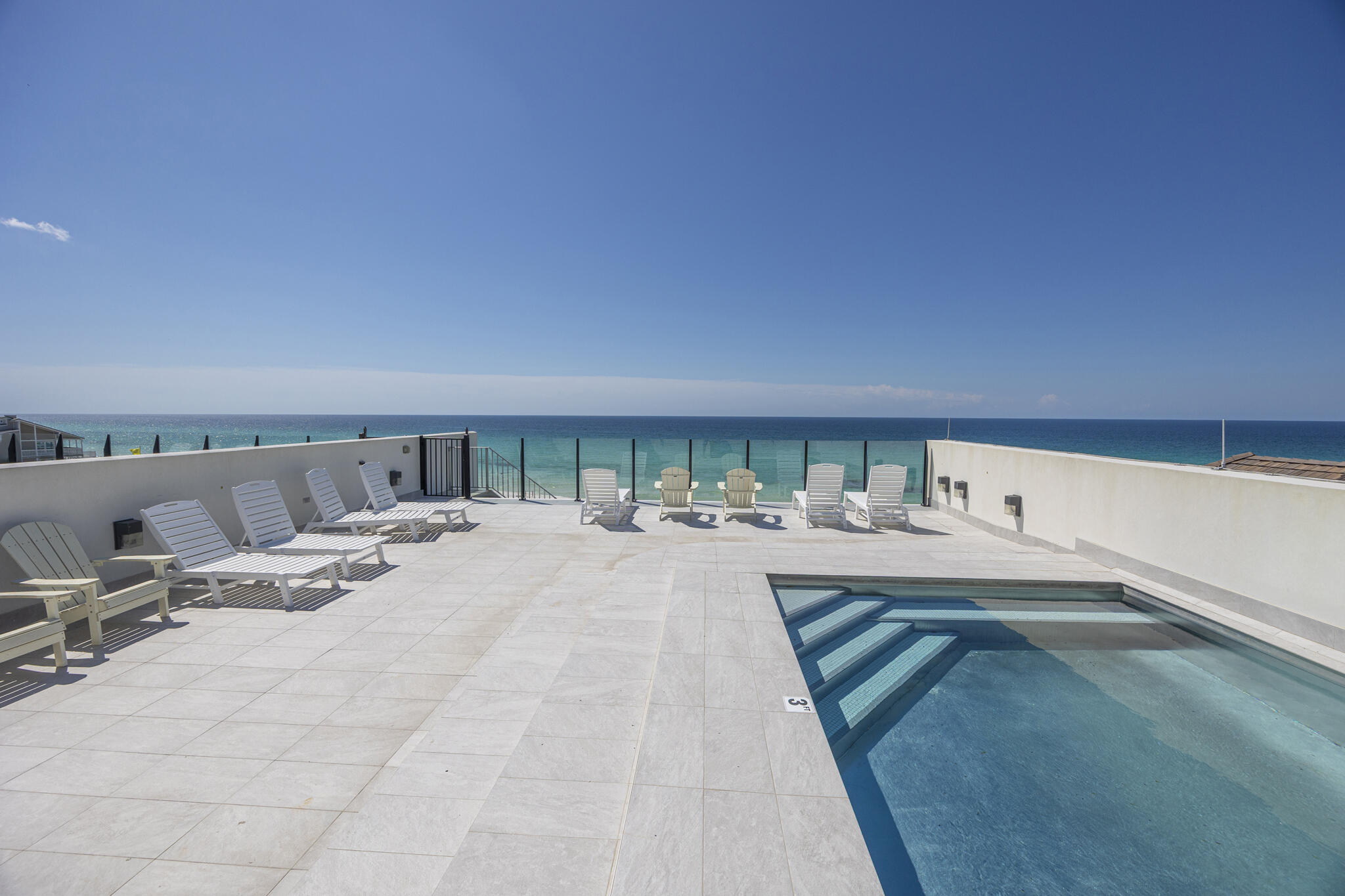 Unique Financing Opportunity! Seller is offering owner financing at 4.5% interest with no origination fees, a 30-year amortization, and a 5-year balloon. Perched along 109 feet of pristine Gulf frontage, this exceptional 4-bedroom, 4,272 sq ft coastal retreat offers a rare blend of space, privacy, and direct beach access via a shared dune walkover with Unit B, all set on nearly an acre of coveted shoreline. A rooftop pool & multiple Gulf-facing balconies provide a stunning backdrop of panoramic coastal views. Designed by Eric Craig of B. Design, the home reflects a sophisticated blend of architectural precision & coastal elegance. Interiors feature soaring 9-10ft ceilings, wood-look porcelain tile, spruce accents, custom mosaics, and curated designer lighting, creating a refined yet relaxed atmosphere throughout. Built with ICF construction & impact-rated glass, the residence prioritizes durability, efficiency, and comfort with multiple high-efficiency HVAC systems, integrated dehumidification, tankless gas water heating, and full smart-home capabilities. A crisp white exterior, paver drive, and spacious 3-car garage with additional parking enhance both form and function. The first level is tailored for entertaining, featuring a spacious game room with wet bar and full bath, ideal for seamless transition from beach to home. A private elevator connects all four levels, each offering light-filled living spaces and Gulf-front vantage points. The rooftop terrace serves as a showpiece, complete with a stainless steel pool, expansive sun deck, and glass railings framing unobstructed views of the shoreline.

The main living level showcases an open-concept design where the kitchen, dining, and great room flow effortlessly together, all oriented toward the Gulf through expansive glass. Elevated details include a coffered ceiling, LED fireplace, and professionally curated interiors. The chef's kitchen is appointed with Sub-Zero refrigeration, a Wolf dual-fuel range with 8-burner gas cooktop, wine cooler, custom cabinetry, and striking backsplash.

Upstairs, two Gulf-front suites with private balcony access are complemented by a versatile living space with wet bar, offering both comfort and flexibility. The top level is dedicated to a luxurious primary suite with sweeping Gulf views, a spa-inspired bath, and generous walk-in closet, along with an additional Gulf-front guest suite and convenient pool bath.

Offered fully furnished and professionally designed, this turnkey property presents an outstanding opportunity as a primary residence, second home, or a high-performing investment. With proven rental success generating $229K in 2025, the property delivers both immediate income potential and long-term value. Smart-home integration allows for effortless remote management of climate, security, pool, and garage systems.

Tucked along a private, palm-lined street shared by only three other Gulf-front residences, Azzurro offers a rare balance of privacy and accessibility. Located in the heart of Seagrove Beach, it is just moments from the vibrant communities of Seaside, Alys Beach, and Rosemary Beach, as well as beloved local destinations including Old Florida Fish House, Buddy's Seafood Market, and Beachy Bean Coffee. Nearby coastal dune lakes, state parks, and scenic bike trails further enhance the lifestyle. Azzurro is a true Gulf-front retreat, where timeless design meets modern luxury in one of 30A's most sought-after settings.