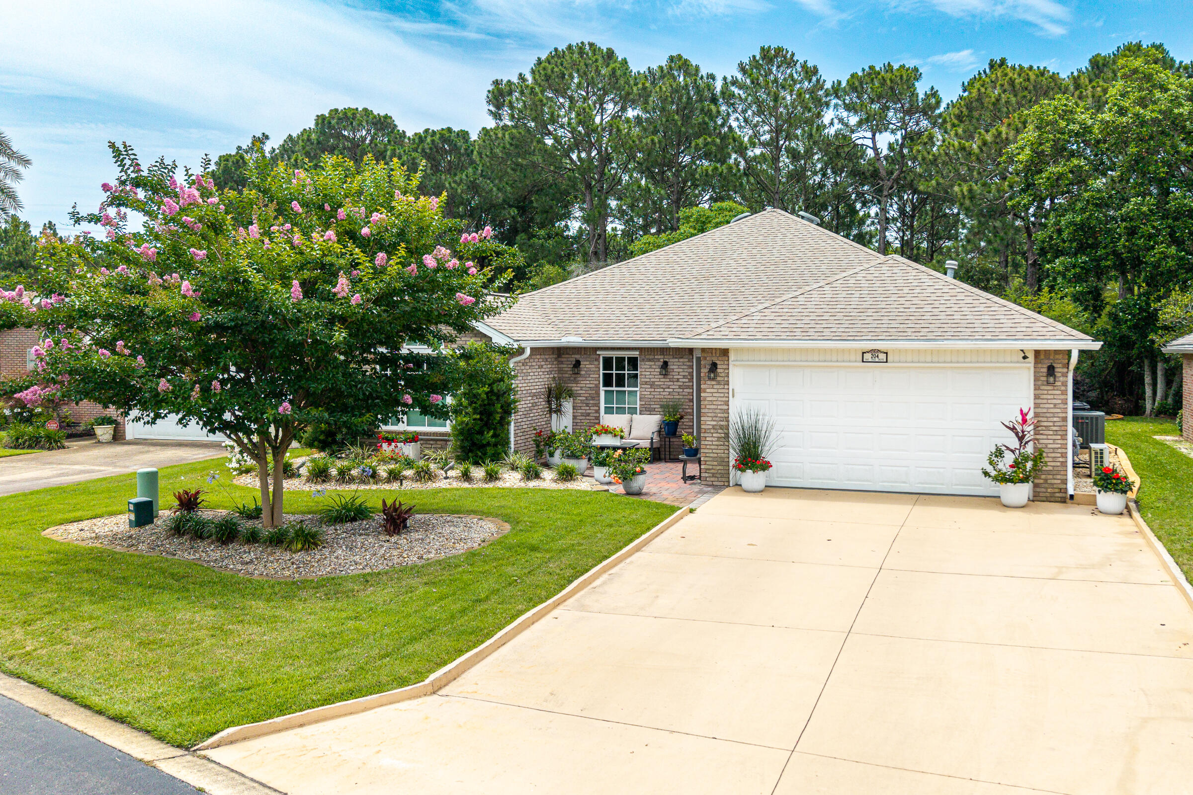 Beautifully updated and meticulously maintained single-story brick home in the sought-after Bayside neighborhood offering exceptional amenities including a community pool, pavilion, tennis and pickleball courts, playground, and a scenic bayfront dock. The beautifully landscaped exterior showcases new rock beds, greenery, flowering shrubs, and lush natural surroundings, all perfectly positioned against protected wetlands that provide exceptional privacy and peaceful views. Step inside to discover gorgeous LVP flooring throughout and a completely reimagined kitchen featuring waterfall quartz countertops, custom cabinetry, a spacious island, and new stainless steel appliances. Two walls were strategically removed to create an open-concept living and dining space filled with natural light, while elegant French doors now lead into a heated and cooled Florida Room--perfect for year-round enjoyment. The primary suite has been thoughtfully redesigned to maximize both comfort and storage, featuring a spacious walk-in closet created from the enclosed screened patio, dual vanities, additional built-in storage, and a beautifully updated walk-in shower. Major system upgrades provide peace of mind, including high impact windows and garage door, hurricane shutters, a full-house Guardian generator, Trane HVAC system (2017) with air cleaner, Trane mini-split system for the garage, and a Rinnai tankless water heater. This home is a must see!