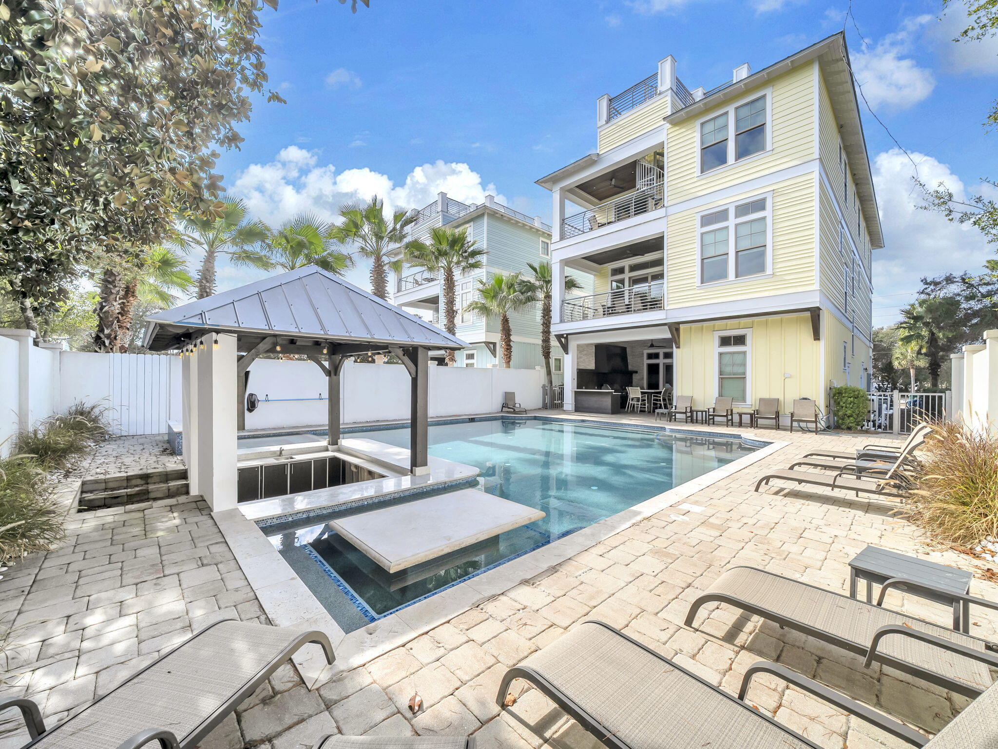 71 Dolphin Street is a truly unprecedented luxury beach home in the highly sought-after Crystal Beach area of Destin. This stunning three-story residence blends contemporary coastal design with premium amenities and exceptional versatility, making it perfect as a private estate, second home, or investment property with proven rental performance. The crown jewel is a 60,000-gallon private pool and spa, complete with a sunken swim-up bar, outdoor summer kitchen, and entertainment areas, creating an exceptional resort feel right in your backyard. With eight bedrooms and eight-and-a-half bathrooms thoughtfully placed throughout the 5,889 square feet, friends and family will find plenty of room to get comfortable. Enjoy the expansive open floor plan, ideal for entertaining, including a sleek chef's kitchen with high-end appliances, custom cabinetry, and a large center island. Multiple living and lounge areas, including a game room with a wet bar, are perfect for gatherings or relaxation. Another great feature is the elevator, allowing you to skip the stairs. Forget the long treks to the shore,this home is located just steps from the Gulf of Mexico. Where Dolphin Street terminates, you will find a brand-new beach access located approximately 175 yards from your doorstep. Enjoy the convenience of morning walks on the sugar-white sands and sunset views over the turquoise waters with incredible ease.