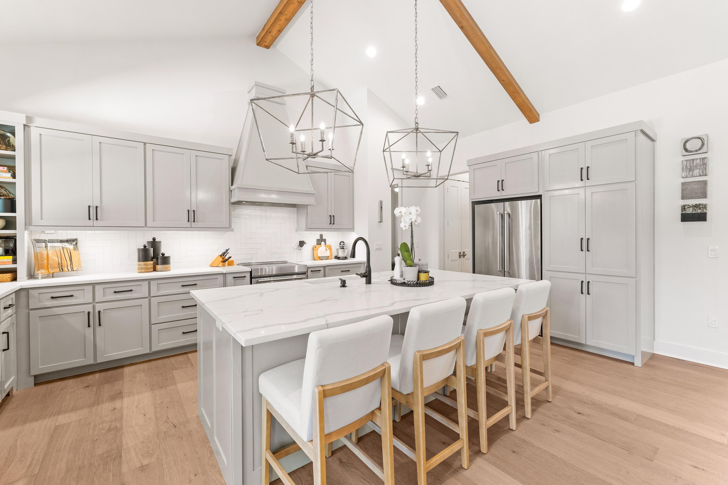 Under Contract with a 48 Hour Kick-Out Clause | Introducing 51 Morning Sun Court, a beautifully crafted four-bedroom, three-bathroom home that perfectly blends luxury, comfort, and thoughtful design. Built in 2019, this custom single-level residence is located in the sought-after and rental-restricted Pelican Bay community--just minutes from Choctawhatchee Bay and a short drive to the stunning beaches of South Walton. Inside, an inviting open floor plan showcases 14-foot cathedral ceilings, a cast stone fireplace, and Pecky cypress accents that bring warmth and character throughout the foyer, kitchen, and dining areas. The gourmet kitchen features quartz countertops, a hooded induction range, KitchenAid appliances, and a spacious breakfast bar, creating the perfect setting for everyday living and entertaining. The primary suite offers a serene retreat with dual walk-in closets featuring built-ins and a spa-inspired bathroom complete with two vanities, a standalone soaking tub, and a walk-in tiled shower. Three additional guest bedrooms and two full bathrooms, all finished with quartz counters and ceramic tile, provide comfort and privacy for family and guests. A well-appointed laundry room, conveniently located off the garage, includes full countertops, a sink, and charming penny tile flooring. Outside, the fenced backyard offers generous space to create your own outdoor oasis, with room to add a private pool or patio area. Set on a meticulously maintained lot, this property is ideally positioned near top-rated schools, Grand Boulevard, and the Gulf of Mexico. Residents of Pelican Bay enjoy access to a bayfront park with a community dock, picnic area, and a pickleball and tennis court for the perfect balance of relaxation, recreation, and coastal living.