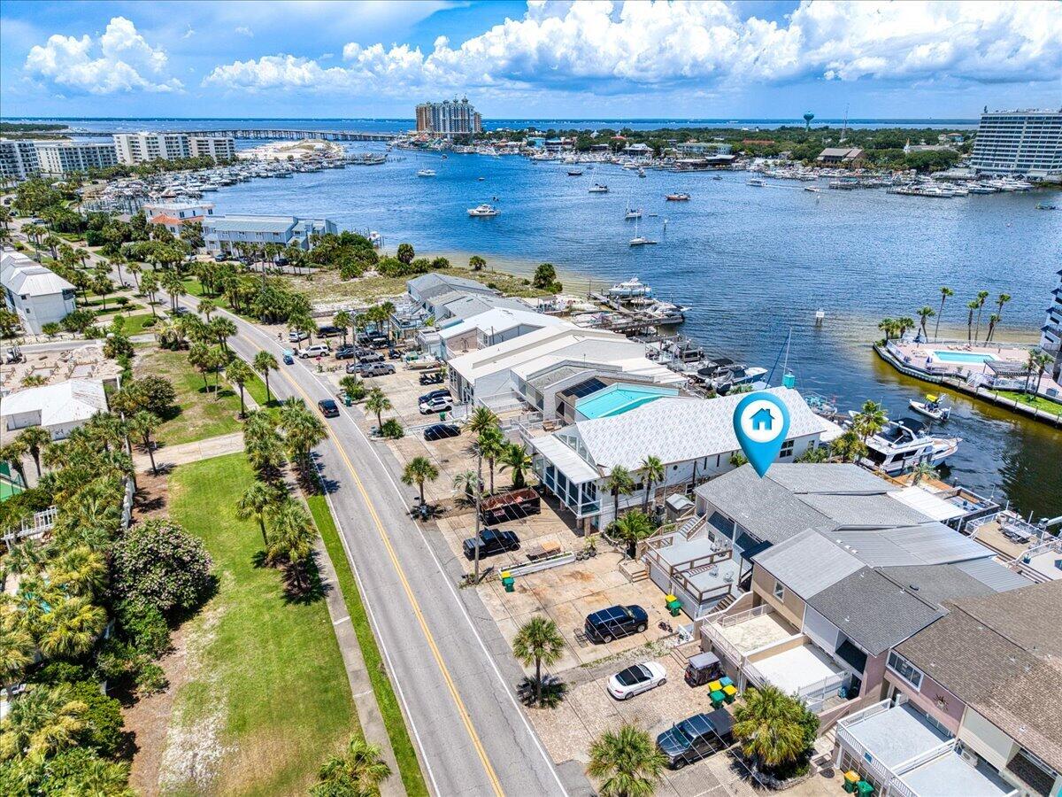 Destin/Holiday Isle WATERFRONT TOWNHOME with Great view of the harbor from the newly renovated exterior decks. Use as a Vacation Home or Investment Property with Short- or Long-Term Rentals! 
Dock your Boat right in your Back Yard!  Roof was installed in 2018, Two HVAC's, one was replaced in 2023 and the lower unit in 2017. 38 Gallon Hot Water Heater replaced in 2018. Seller had them recently serviced. Unit has ground floor apartment complete with living room/dining room combo; kitchen with breakfast bar, refrigerator, stove, garbage disposal; bedroom has two closets and full bath. Bedroom also has stairway leading to second floor of upstairs unit Downstairs unit also has its own a/c. Second floor includes large living room with view of harbor, two bedrooms with bathroom between.3rd floor includes bright and airy kitchen (stove, refrigerator w/ice maker, microwave, garbage disposal, dishwasher, breakfast bar, dining area and bathroom (shower only). Third floor has ceramic tile. Ceiling fans throughout and lots of closet space. One car garage that can be accessed from second floor. Property also has 28' boat tie up at Dock/Sea Wall . Come view all the potential this property has and view the Destin Harbor from the Back Deck!