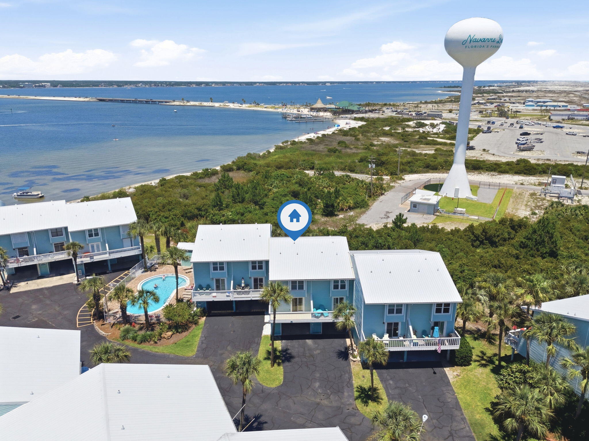 COASTAL MODERN RETREAT with SPECTACULAR SOUND VIEWS & TURNKEY INVESTMENT POTENTIAL! Experience the best of Navarre Beach living in this beautifully renovated coastal-modern townhome, perfectly positioned between the sugar-white sands of the Gulf and the tranquil waters of Santa Rosa Sound. Designed for both relaxation and entertaining, this stunning property showcases breathtaking Sound views, multiple outdoor living spaces, and a seamless blend of modern comfort and coastal charm. Enjoy your morning coffee as the sun rises over the water, spend afternoons soaking in the coastal breeze, and unwind in the evening from one of the private decks or thoughtfully designed outdoor gathering areas. Inside, the bright and airy open-concept floor plan has been thoughtfully updated with a beautifully remodeled kitchen, updated bathrooms, and stylish coastal finishes throughout. The inviting living spaces flow effortlessly outdoors, creating an exceptional indoor-outdoor lifestyle rarely found in comparable properties. A unique lower-level outdoor lounge and dining retreat offers the perfect setting for entertaining guests or creating unforgettable vacation memories. Being sold fully furnished and completely turnkey, this property is ready for immediate enjoyment or rental income. Whether you're seeking a primary residence, vacation getaway, or high-performing investment property, this home checks every box. Located directly across from public beach access, popular waterfront restaurants, and the iconic Navarre Beach Pier, you'll enjoy one of the area's most desirable beach locations. Residents also enjoy access to outstanding community amenities, including a heated pool, gazebo, dock, fish-cleaning station, and boat slips. Recent improvements include a new roof installed in 2024. Even better, HOA fees remain among the lowest on Navarre Beach and include high-speed internet, DIRECTV, trash service, roof coverage, and exterior maintenance--providing exceptional value and ease of ownership. Offering stunning water views, upscale updates, exceptional outdoor living, and strong rental appeal, this coastal retreat presents a rare opportunity to own a slice of paradise in one of Navarre Beach's most sought-after locations.