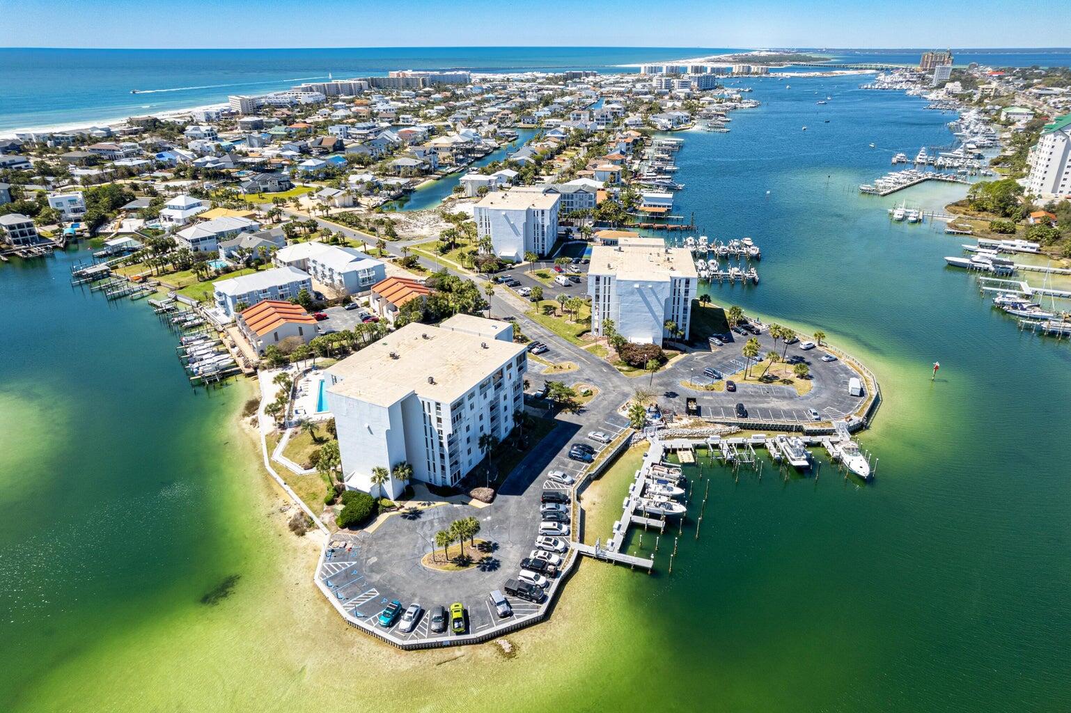 WELCOME to your WATERFRONT OASIS! This PENTHOUSE is located in the heart of Destin, FL. on HOLIDAY ISLE! Unit 701C includes privacy, seclusion and  GORGEOUS VIEWS of the Destin Harbor+ Gulf! This is a 3bed/2bath 1,850sq.ft. condo that has so much to offer and potential, from the 3 HUGE BEDROOMS, to high ceilings, limited to only the top floor units. It is very spacious w/ natural light flowing throughout w/ neutral painted walls and decor. Comes fully furnished except for some personal items and staging items. Great layout and beautiful crown molding. New HVAC+ Hot Water Htr replaced in 2024. Start your morning with coffee overlooking the harbor, spend the afternoon at the beach through PRIVATE GATED BEACH ACCESS just a few blocks away. Relax by the pool or simply watch the boats + dolphins play right from your private patio on the top 7th floor. Boaters will love the waterfront setting, with slips periodically available for separate purchase or rental (slip does not convey). Hurricane grade window + sliding door replacements are required and in process to be completed in this unit by November. Community improvements include gated entry, waterproofing, patio/railing improvements, updated clubhouse, new pool house & golf cart parking. Whether a full-time home, coastal retreat or investment, enjoy HARBOR VIEWS, BEACH, BOATING & the laid-back DESTIN LIFESTYLE from your very own PENTHOUSE above the harbor! DOLPHIN POINT CONDOMINIUM'S offers an exceptional waterfront lifestyle with a variety of amenities for owners, residents and guest's to enjoy. The newly gated community features a tennis and pickleball court, barbecue grills, outdoor dining tables, and two private white-sand beach areas located on both sides of the harbor, complete with chairs for relaxing and enjoying the water views, sunrises, sunsets and boats passing by. The beautiful beach is a short distance with a private access code and gate.  Golf-cart parking is allowed near the private entrance to Gulf for quick access and is on a first come basis. A designated water taxi pickup area adds to the resort-style amenities of Dolphin Point, allowing owners and guests to travel by water to harbor-front restaurants, Harbor Walk Village, shopping, entertainment, and local attractions while enjoying beautiful views of the Destin Harbor.   

Additional conveniences include docks w/ private boat slips, located behind each building, a newly renovated waterfront clubhouse with an outdoor patio overlooking the harbor, and has available storage for golf carts, kayaks , canoes and paddleboards.  Boat slips for purchase when available and some are available for short term/long term rental.  

Residents enjoy easy access to boating, fishing, paddle sports, and waterfront recreation, all within a beautifully maintained community in the heart of Destin.  This condo is directly on the Destin Harbor and is right around the corner from the world famous Crab Island, which is a boaters dream!  Super close to the beach, so you truly have the BEST OF BOTH WORLDS!