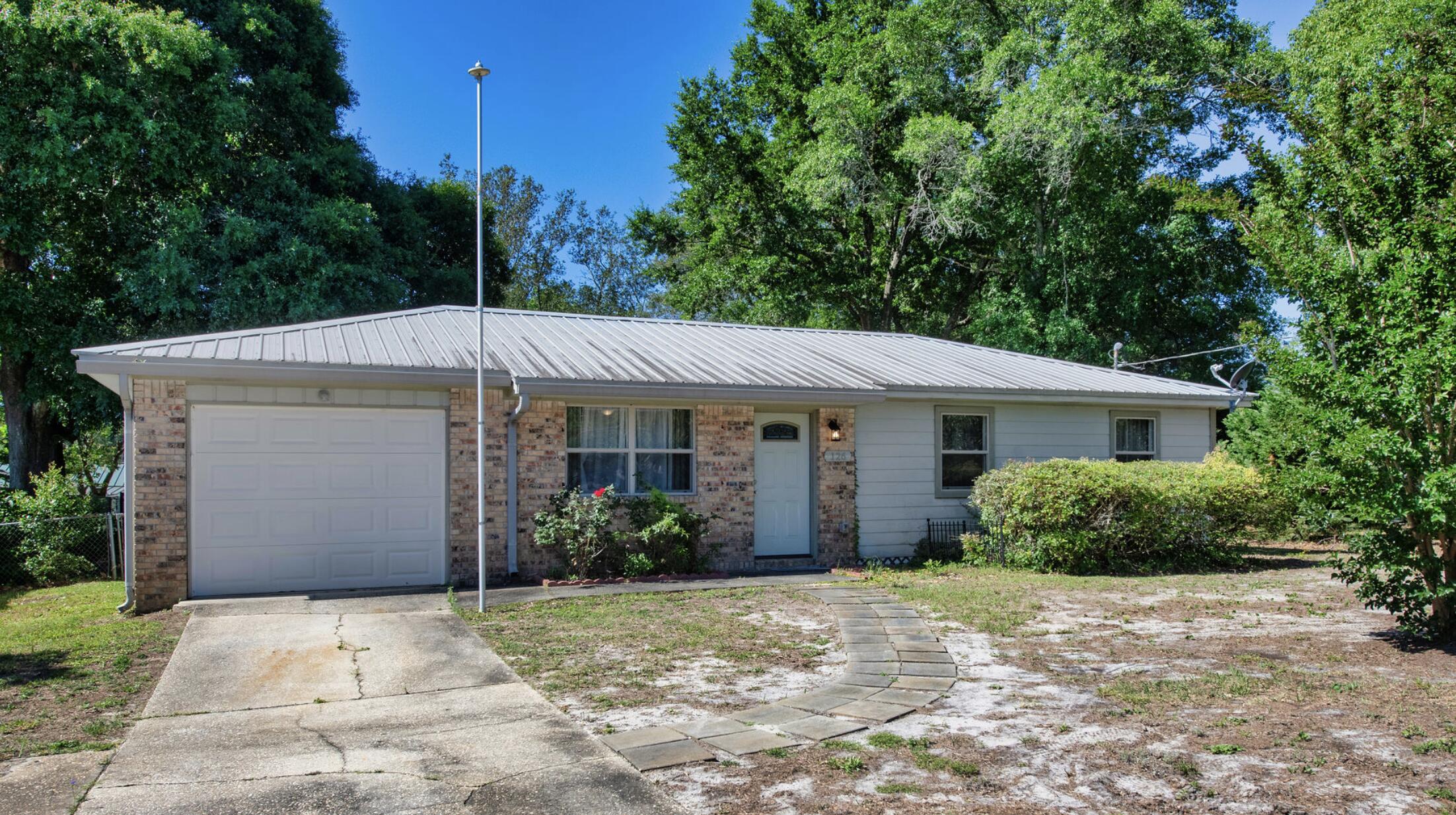 Welcome home to this updated 3-bedroom, 2-bath residence centrally located in Fort Walton Beach. Recent improvements include a remodeled kitchen featuring updated cabinetry, countertops, backsplash, and stainless-steel appliances. The home also offers an attached garage, sprinkler system, and lawn pump to help simplify yard maintenance.

Major system updates include a metal roof installed approximately 9 years ago, HVAC system replaced approximately 5 years ago, and water heater replaced approximately 8-9 years ago. Natural gas is available to the property, though all current appliances operate on electricity.

For added peace of mind, the seller recently completed pre-listing inspections and addressed recommended repairs prior to bringing the home to market.

Enjoy outdoor living on the spacious rear concrete patio overlooking a private backyard with mature landscaping, including abundant ferns and Mexican petunias. A side gate provides convenient backyard access for boat, trailer, or personal watercraft storage.

Conveniently located near shopping, dining, entertainment, Eglin Air Force Base, Hurlburt Field, and the Emerald Coast's renowned white-sand beaches and emerald waters.
