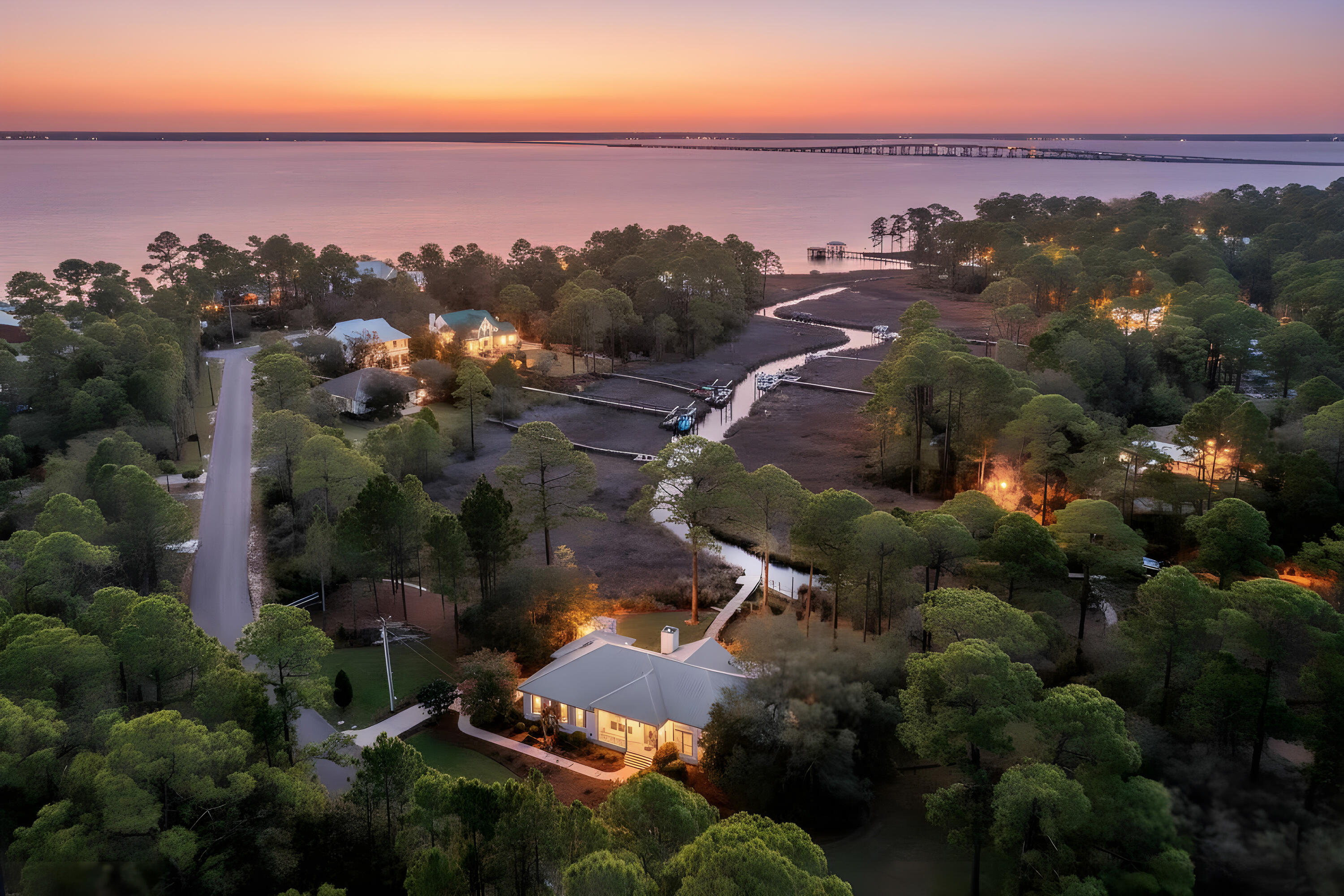 This rare 1.2-acre waterfront property is a truly distinctive navigable waterfront setting with sweeping views of a state protected estuary and Choctawhatchee Bay.  Here is a unique blend of natural beauty and privacy within the quiet upscale bay front community of Bay Pine Shores with paved Cul de sac streets.  The 325 ft. wide property provides privacy and has 230 feet of very navigable waterfront and private dock from which to cruise into the bay and onward to the gulf for all types of water recreation and fishing.  The property has ample space to add a private pool and a carriage house.

This very thoughtfully updated, meticulously maintained custom-designed home has soaring ceilings, spacious and open living areas with scenic water views and outdoor connectivity from every room to porches and a large covered, screened porch.

The location of this home is just 4 miles from Gulf beaches, state parks, all that Scenic HWY 30A offers and close to nearby shopping, dining and Ascension Sacred Heart Hospital. A spacious, covered screened porch also captures the panoramic views, overlooking the peaceful setting surrounded by mature oaks, magnolias, azaleas, and camellias that create a quiet, park-like landscape.
Property upgrades include hardwood floors, a new guest shower, updated PEX plumbing, and freshly repainted walls and cabinets throughout, and feature a 40-year steel roof, an oversized garage, and generous driveway parking. A second large driveway accommodates a camper or boat, and an additional Florida Dock Permit offers the opportunity for a second dock and boat lift, if desired.
Ideally located just minutes from the Gulf beaches, Scenic Highway 30A, state parks, marinas, shopping, dining, and entertainment, and with convenient access to healthcare including Ascension Sacred Heart Hospital, this property offers a rare balance of waterfront privacy and everyday accessibility.