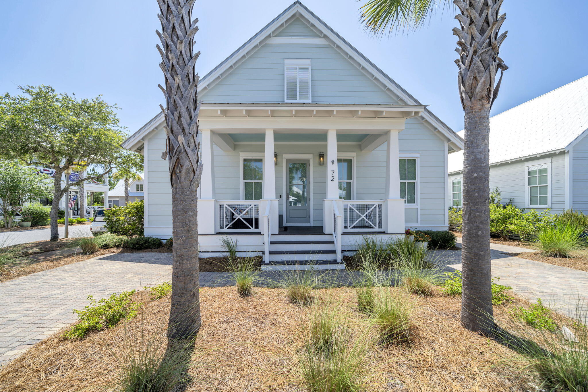 This beautifully designed single-level home features 3 bedrooms, 2.5 bathrooms, and a prime location directly across from the community pool. Thoughtful craftsmanship is evident throughout, with rich walnut hardwood flooring, custom barn doors, soaring vaulted ceilings in the living, dining, and kitchen areas, and 10-foot ceilings throughout the remainder of the home. The well-appointed kitchen is equipped with stainless steel appliances, including a gas range and wine refrigerator, while a convenient side entrance provides easy access to the outdoor grilling area. The spacious primary suite offers dual walk-in closets, with one designed as a lockout for added flexibility and storage.