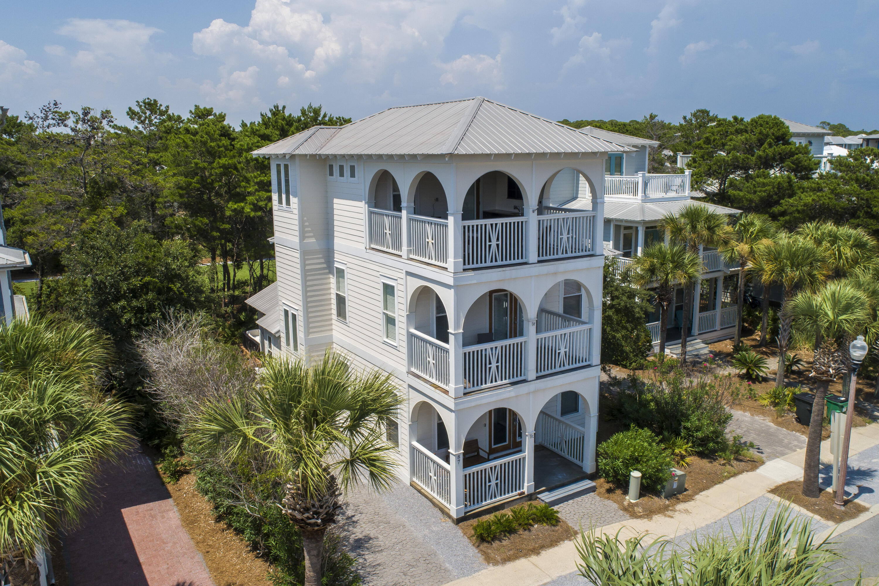Vacation rental in the heart of Seacrest Beach with the very rare feature of being positioned on a large lot which could allow for additional house expansion, carriage house or private pool to be added. This 3-story coastal beach house provides steady rental income as it is, with 3 traditional bedrooms and 2 other sleeping areas including a 3rd floor bunk room with terrace. The lot backs up to one of my favorite green spaces in the entire neighborhood which gives it a secret feel. Seacrest community pool is spectacular, and HOA includes tram and beach access. pool quote available- or bring your own design.