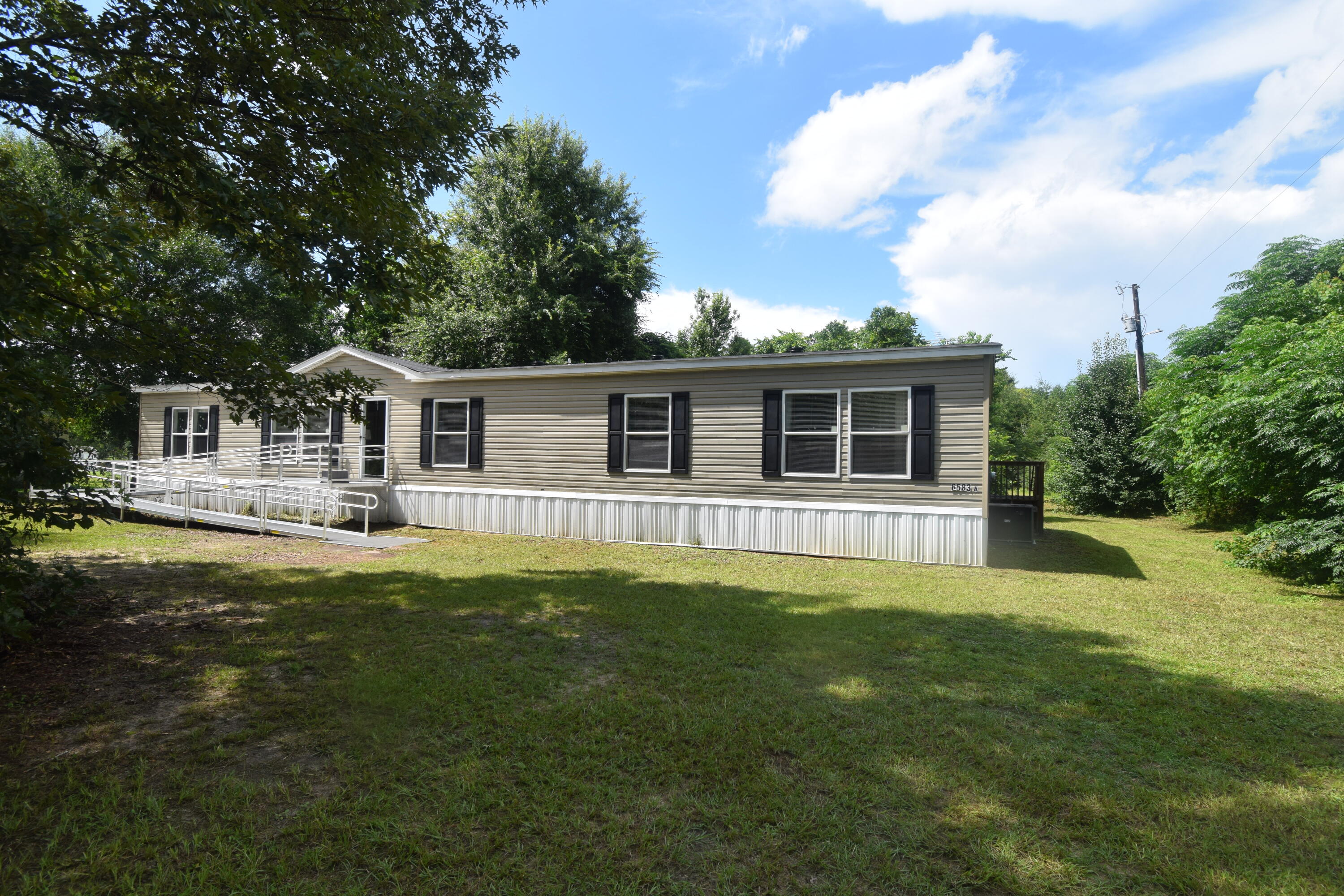 Experience the perfect blend of modern comfort and country living in this 2024 manufactured home situated on 1.25 acres. Offering 4 spacious bedrooms, 3 full bathrooms, an additional family room, and a dedicated laundry room, this home provides plenty of space for everyone. The split floor plan features generously sized bedrooms and a large primary suite with an oversized bathroom designed for comfort and relaxation. Enjoy peaceful country living while remaining just minutes from town, offering the best of both worlds. Several outbuildings are located on the property and will convey as-is. Don't miss this opportunity to own a nearly new home with room to spread out both inside and out! Give me a call today to view this home!